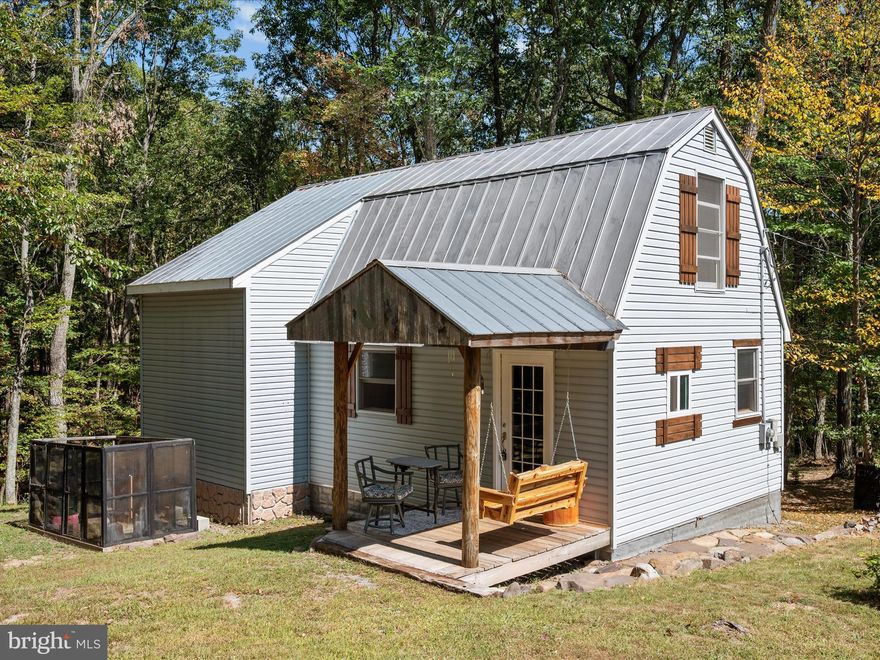 Make this private, serene, custom cabin on 2+ acres off a WV cul-de-sac with access to Short Mtn Wildlife Management (8,000 acres of trails and hunting) your next place. Great for full time living as a 2 bed, 1 bath home with carport and additional detached studio space OR as a recreational cabin which can comfortably sleep 8 PLUS the studio space. A gravel driveway circles behind the carport creating plenty of easy parking. On the main level you'll find all the essentials: kitchen, dining, living, laundry, full bath and bedroom but with extras that really make this home shine--Custom cabinets and interior door, tons of natural light with views great for watching deer, birds, bear and weather, vaulted ceilings, wood burning stove & under stair storage. The loft is accessed by French doors and can easily accommodate 2 queen beds with plenty of storage available. Outside you can take advantage of the studio space as an option for guests, storage, office, etc. Both the studio and carport have electric. Leland Cypress line the road frontage offering even more privacy.