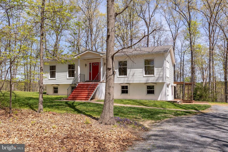 Nestled on a serene 3.2-acre lot with a picturesque creek, this beautifully maintained 3-bedroom, 2-bath raised rancher offers the perfect blend of comfort, space, and nature. The upper level features gleaming hardwood floors, an open layout, and a conveniently located laundry room. Enjoy the  atmosphere of the finished basement, complete with luxury vinyl plank flooring, a gas fireplace, and custom built-ins—ideal for a family room, home office, or entertaining space.  Step outside to a spacious rear deck perfect for morning coffee or evening gatherings, with stairs leading to a lower-level brick patio that extends your outdoor living area. A covered front porch welcomes you home and adds to the home's country charm. This property offers peace, privacy, and practicality all in one package—don’t miss your chance to own this special retreat!

All updates approximate, including HVAC's 2022, Furnace 2022, water heater 2018, septic pumped 2019, pressure tank 2024.