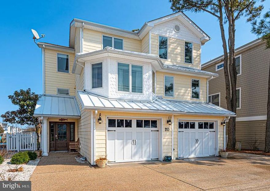 Waterfront and Walk to the Beach! Your coastal retreat awaits in sought-after South Bethany. This beautifully maintained four-bedroom, three-full-bath home with garage and private boat dock is perfectly situated on a wide canal with expansive water views at the canal intersections, offering the best of beach and boating lifestyles. The first level features two bedrooms, a full bath, laundry room, and a spacious waterfront family room with dining area and convenient wet bar complete with refrigerator, dishwasher, and microwave. Step outside to the waterside paver patio, which leads directly to your private boat dock. The main living level offers an open-concept great room and gourmet kitchen with a spacious island, newly installed dry bar, dining area, and a main-level bedroom with full bath. The great room with fireplace opens to a screened porch and new coastal-style deck, perfectly positioned to take in the serene water views. The third level features the private primary suite with a beautifully tiled shower and soaking tub, plus a loft area overlooking the great room is ideal for a desk or home office. A private balcony completes the space, offering yet another spot to enjoy the peaceful canal views. Additional highlights include vaulted ceilings, hardwood floors, outdoor shower, fenced yard, covered patio, and garage. Being sold mostly furnished, this home is ready for immediate enjoyment as a year-round residence, vacation getaway, or investment property. After you stroll back from the beach, return home to your dock, take the boat out on the bay to waterfront restaurants, toss a line to fish, crab, or clam - or relax while watching the sunset over the water. Private showings only.