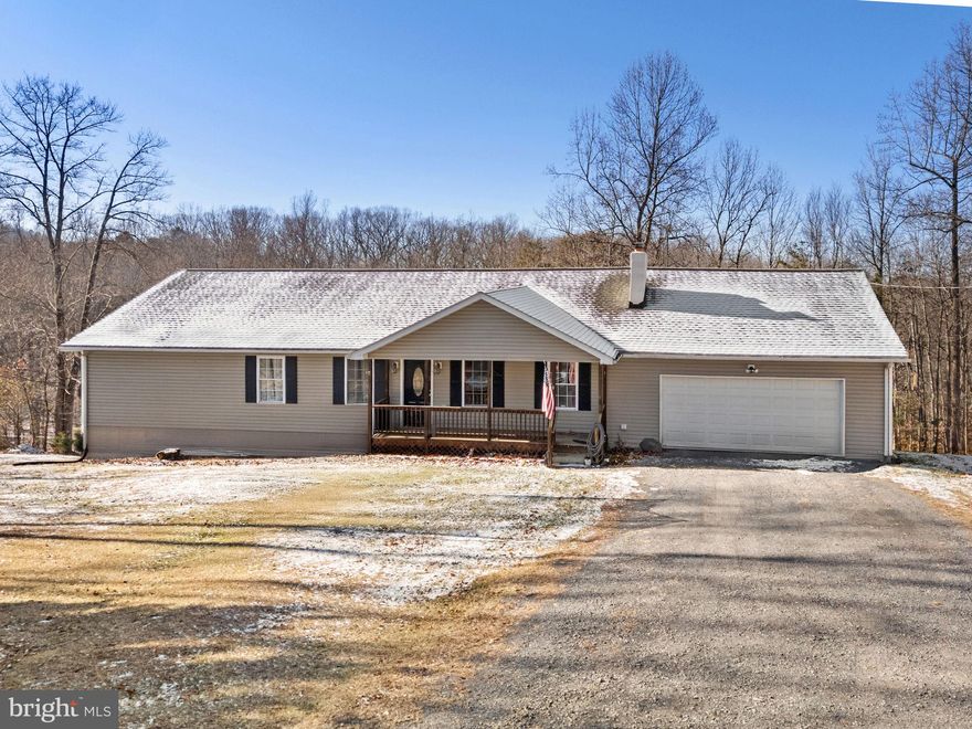 Tucked away on 5 private, unrestricted acres, this home offers peace, privacy, and room to grow. Inside, you’ll find light-filled living spaces, beautiful hardwood floors, and a freshly painted interior. The spacious living room features a cozy fireplace and flows seamlessly into the eat-in kitchen, which offers ample cabinetry, generous counter space, and access to the rear deck—perfect for outdoor dining or relaxing.

The primary suite includes a walk-in closet and an updated attached bath. The walk-out unfinished basement provides excellent expansion potential and is already roughed in for a future bathroom.

Recent improvements add peace of mind, including a new roof in 2025, HVAC replaced in 2015, and a water heater replaced in 2023. Exterior features include a shed, chicken coop, fenced pasture, and partially fenced yard, offering added flexibility for pets, hobby farming, or outdoor enjoyment. A rare opportunity to enjoy acreage, privacy, and versatility in a peaceful setting.