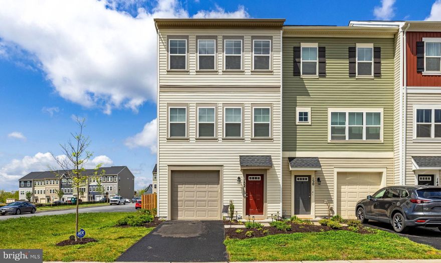 Experience modern living and a vibrant community lifestyle at 152 Galaxy Place. This pristine, two-year-old end-unit townhome is located in the highly sought-after Snowden Bridge neighborhood, offering an unparalleled lifestyle known for its incredible amenities. Residents enjoy access to a massive recreation center, a swimming pool with a water park, indoor tennis and basketball courts, a dog park, miles of scenic trails, and more. Perfectly positioned for the modern professional, this location is a commuter’s dream, providing swift access to major routes while keeping you just minutes away from the shopping, dining, and historic charm of Winchester. The interior is designed for effortless flow, beginning on the entry level with a large family room that includes a half bath and walk-out access to the private, fenced-in backyard. On the second level, an expansive living room filled with natural light opens into a bright eat-in kitchen. This space is well-equipped with white cabinetry, stainless steel appliances, a pantry, and a large breakfast bar for additional seating. A sun-filled dining area and a second half bath complete this central living space, offering an ideal setup for everyday comfort and entertaining. The upper level features a spacious primary suite with a large walk-in closet and a private ensuite bath featuring double sinks, a walk-in shower, and a soaking tub. Two additional bedrooms and a second full bath provide plenty of space for family, guests, or a home office. Complete with a 1-car attached garage, a private driveway for off-street parking, and excellent curb appeal, this low-maintenance home offers a turnkey opportunity to own in one of the area’s most premier communities. Don't wait to make this exceptional property and the incredible Snowden Bridge lifestyle your own.