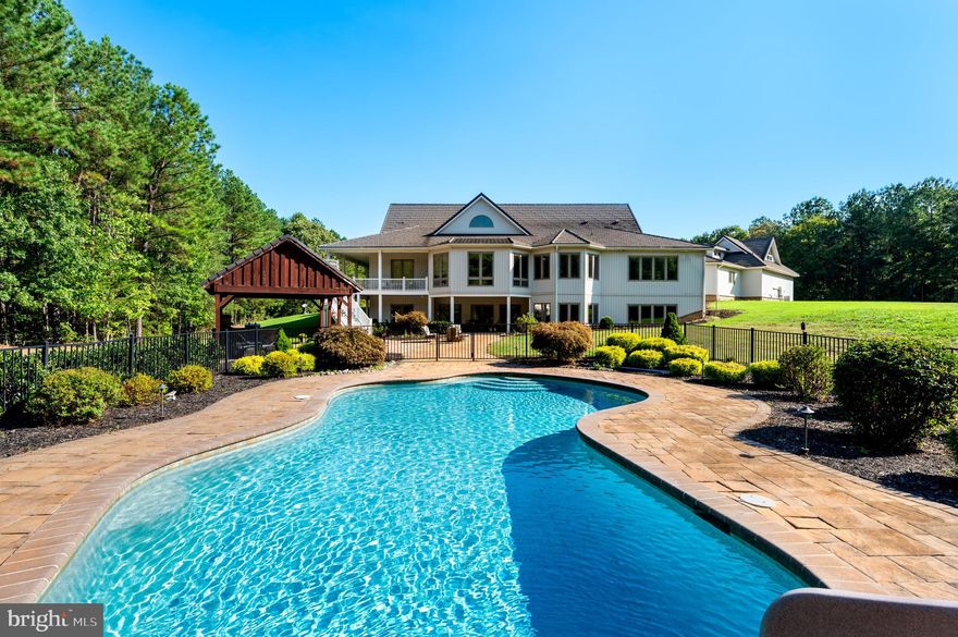 Welcome to a breathtaking, unparalleled, retreat in Calvert County, Maryland, where luxury meets nature on a remarkable 103-acre estate. Enter through elegant gates and meander up a breathtaking lane that unfolds to reveal a stunning, picturesque setting and the grand main house, a true masterpiece of modern contemporary design.

Spanning over 8,000 square feet, this meticulously updated home features a spectacular main family room with soaring 23-foot ceilings, creating an inviting lodge-like atmosphere. If you are looking for lodge-chic, this is the place for you! The spacious kitchen, equipped with high-end appliances, is perfect for culinary enthusiasts and gatherings alike.

Enjoy tranquil afternoons in the sunroom or step outside to your private oasis. The expansive outdoor area includes a large pool, exquisite hardscaping, multiple decks, a charming pavilion, an outdoor kitchen, and a cozy fire pit—ideal for entertaining or relaxing under the stars.

With 5 well-appointed bedrooms and a large wet bar in the walk-out basement, this residence is perfect for hosting family and friends. A separate guest house, with radiant heated floors, provides an additional accommodation for guests. While the three-car attached garage, 40 x 60 with hydronic heated floor pole barn and detached workshop offer ample storage and functionality.  The pole barn has 10x10 doors on each end, extra cabinets, ceiling fans, insulated walls and insulated attic and a 50-Amp outlet for welding. 

This property is not only a serene escape but also an adventurous playground. Whether you envision a corporate retreat, private hunting grounds, space for horses and livestock, or a family compound, the possibilities are endless. Enjoy the trails that weave through the wooded areas for hiking, trail biking or horseback riding.

For those considering investment opportunities, the estate offers the potential for subdivision into three separate parcels. Buyers are responsible to conduct their own due diligence regarding subdivision possibilities.  Please, no drive-bys. Appointments to see this wonderful oasis are required. 

With dual geothermal HVAC systems and heated, radiant flooring, ensuring year-round comfort, this immaculately maintained home blends elegance with practicality. There are also 2 separate Energy Recovery Systems to maintain air quality and humidity.  Discover the limitless potential of this extraordinary property—your dream lifestyle awaits!