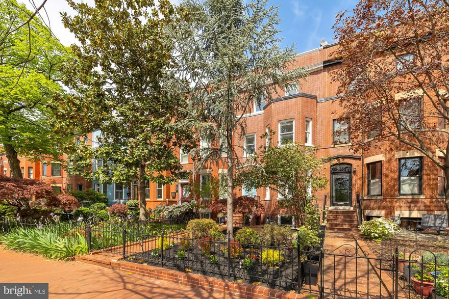 Step into this exquisite rowhome, recently renovated with meticulous attention to detail on a coveted block in Capitol Hill. The separate lower level accessory unit has the potential to generate up to $40,000 a year in Airbnb rental income. Spanning almost 4000 square feet, this residence offers a 3-story main residence with a roof deck and patio, plus a separate lower level unit for easy rental potential. As you enter through the inviting blue door, you're greeted by an expansive living room adorned with several custom built-ins, a cozy fireplace, and stunning original pine floors that are illuminated by the natural light pouring in through the bay window.

The open floor plan leads you to the elegant dining area and into the fabulous brand new designer kitchen, featuring natural quartzite counters, top-of-the-line stainless steel appliances, a large island and ample storage with a wall of custom built-ins.  An updated powder room adds extra convenience to this level. Step outside from the kitchen onto your private deck and down to the separate fenced patio with new semi-permeable pavers, perfect for outdoor entertaining.

Ascending to the second level, you'll discover the large primary suite boasting south facing bay windows, built-ins, and a walk-in closet. The beautiful en-suite bath features a charming brick accent wall, a rain shower, and a soaking tub for ultimate relaxation. A unique library space with built-ins provides versatility as a study or playroom, with a “hidden” bookcase door granting access to the primary bathroom. An additional spacious bedroom and full modern bathroom, along with laundry facilities, complete this level.

Venture to the third floor to find two more bedrooms, two full bathrooms, and a wet bar with beverage fridge, all illuminated by beautiful skylights. Step out onto the expansive private roof deck to enjoy panoramic views of the city skyline.

The separate lower level unit offers a world of possibilities, with 2 bedrooms, 1 bath, and entrances in both the front and back. Ideal as a potential rental for additional income or as an in-law or au pair suite, this space features a living and dining area, fireplace, full kitchen, and washer/dryer.

Located in Capitol Hill just off Stanton Park, this home offers easy access to all the neighborhood has to offer, including great restaurants, shops, Eastern Market, Barrack's Row, parks, Metro and of course, the United States Capitol Building and the Supreme Court.

The sellers have lovingly renovated this home over the past two years. Updates include refinished wood floors on all levels, renovated all bathrooms with Restoration Hardware fixtures and marble tile and repainted the entire interior of the home. The first floor has also been reconfigured to open the kitchen to the rest of the house and additional built-in storage was added. This home truly offers the perfect blend of modern amenities and historic charm in one of DC's most sought-after neighborhoods. Schedule a showing today! All sqft is approximate and not to be used for property valuation.