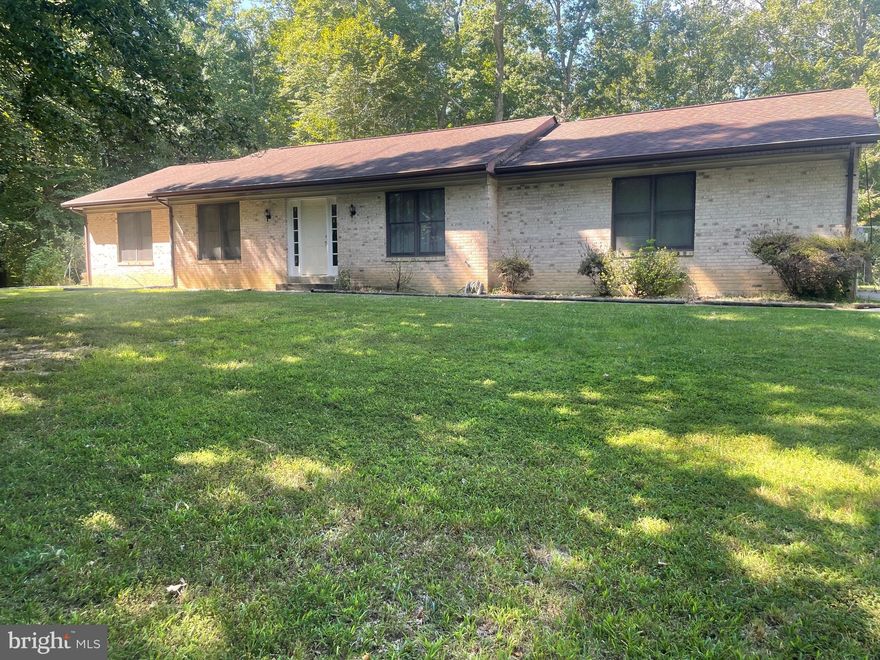 Brick front rambler on a beautiful 3-acre lot with numerous outbuildings in a quiet established neighborhood. Enjoy nature, a serene atmosphere, and privacy with plenty of room for all!  12' X 20' shed in fenced back yard, 40' X 28' detached garage/workshop with electricity and Heat, and 30' X 40' barn/outbuilding with electricity, flooring and attic for storage.  Perfect for a Contractor, Home Business, or your hobbies.  Small pond on the rear of property. The possibilities for this property are numerous!   This is an Estate Sale and being sold strictly AS IS.  House is priced accordingly for the cosmetic touches needed to make this your home!
