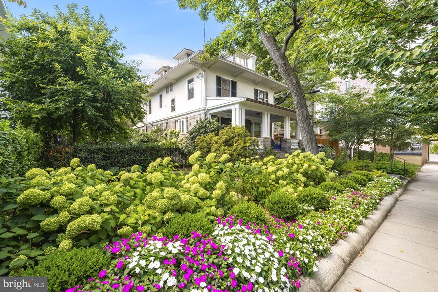 Neighborhood treasure! Beautiful 1909 stone and stucco American Foursquare with over 10,000 SF of lush and level surrounding gardens on prime Cleveland Park block! Airy floor plan features generously proportioned rooms with tall ceilings - all tastefully updated & expanded with many charming period details preserved! Main level includes elegant foyer, large living room with fireplace, gracious dining room, and family room open to the expansive kitchen with spectacular southern light and views of the National Cathedral. Wonderful indoor-outdoor social flow from the wide and welcoming front porch, deep and serene south-facing backyard and substantial side garden. Large primary suite with en suite bath, dressing area, and balcony, plus four additional bedrooms, two additional full baths, and laundry upstairs. Fully finished lower level with family room, kitchen, bedroom, bathroom, and ample storage. Easy parking for 4+ cars in wide driveway, steps to schools, shops, restaurants, everything!