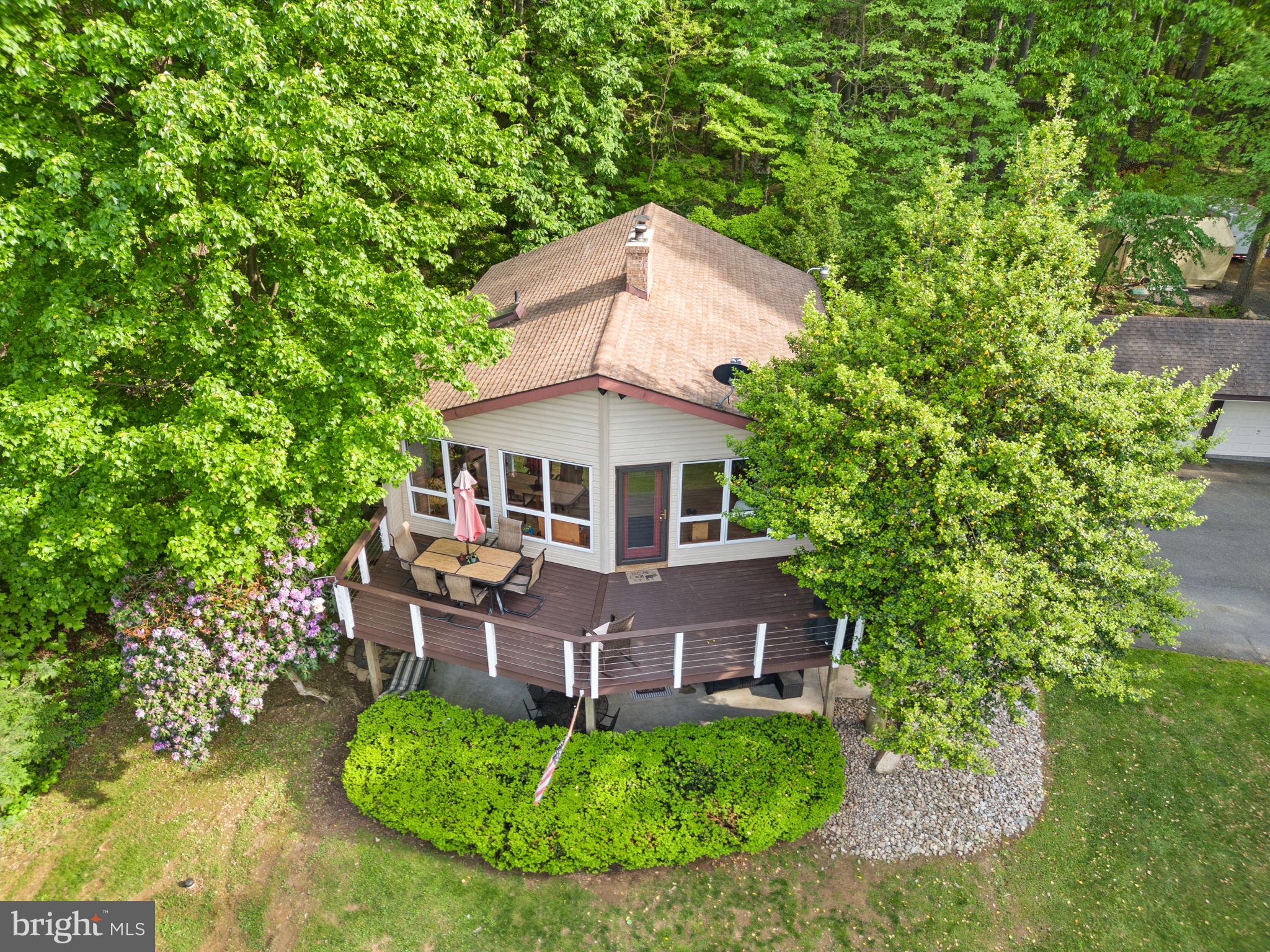 Welcome to your dream retreat! Stunning 4 bedroom A-Frame Contemporary on over 3 acres. This beautiful 4-bedroom, 2-bath A-frame contemporary home sits up a hill providing panoramic views with privacy, peace, and serenity. The expansive wrap-around deck is perfect for entertaining or simply soaking in the natural beauty.
Step inside to a large open floor plan featuring soaring cathedral ceilings, a cozy fireplace in the living room, and abundant natural light. The gourmet kitchen is a chef’s delight with stainless steel appliances, granite countertops, and custom cabinetry.
The lower level offers additional living space with two bedrooms, a full bath, a second fireplace, and walk-out access to a private patio—ideal for guests, in-laws, or a home office.
Outside, enjoy your own private oasis with a tranquil pond, hot tub, and a detached 3-car garage for all your storage needs.
New central air conditioning and heat in January 2024 and back-up baseboard.
Nothing to do but move in—schedule your showing today and make this stunning home yours!