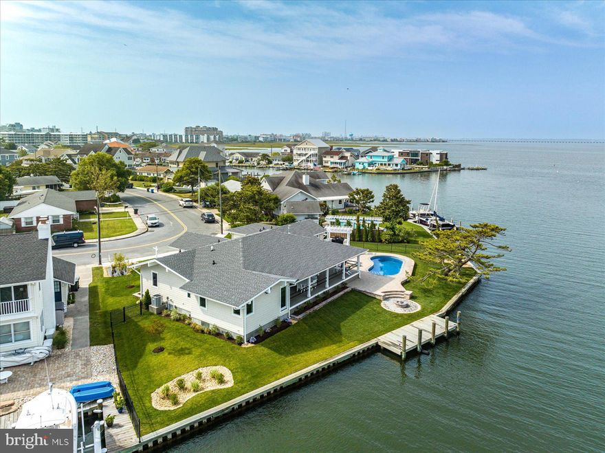 Must See! On  2 .2 very private waterfront lots.  Deep water, great views of Rt 90 bridge and open bay.    Totally remodeled  Home Located in Ocean City’s quiet, highly sought-after waterfront “Little Salisbury Village” (off 87th Street & bay), this fully renovated and expanded Mid-Century Modern home offers luxurious one floor living spaces inside and out. An ever-changing water vista: 140+ feet of gently curved waterfront (with brand new bulkheading) and large backyard is captured through an entire wall of floor-to-ceiling tinted Pella windows and sliders. The single floor home features three bedrooms and four baths (including  2 private en-suite  bedrooms ) . A attached Pool house with kitchenette, ,full bath. and separate hvac system which can be used as a Mother-in-Law suite or 4th bedroom. The authenticity of the Mid-Century Modern feel is captured in the spacious open concept living room with an iconic gas brick fireplace along one wall that is accented with a wraparound hearth, providing beautiful form and function and cozy, social seating. A fabulous gourmet kitchen with beautiful morning light, has a large quartz top island and countertops for entertaining as well as stainless steel appliances including an upscale Chef’s gas range, oven and hood, built-in Microwave, and abundant cabinet/pantry space.  Each room has access to the wide waterfront wraparound deck.  A trellis covered Chef’s BBQ station is located deck side, just outside the pool house doors. With a 13 x 18 attached storage garage there is plenty of room for all your beach gear., the private dock is permitted for a 30 ft pier and two lifts.  Room for a boat and jet skis. No HOA. More photos will be added as construction is nearing completion.  One level waterfront living was never more spacious and beautiful.  Schedule a tour of this unique, one-of-a-kind property today! Remodeled  interior Square footage is 2553  SF. ** Actual, renovated square footage is not reflected in the  current tax records. records ** 
**Over 2000 SF of  porches and decks!  Pool and Pool deck are now included in the listed price!
During construction, the house was raised 3 feet and now features a dry, encapsulated crawl space with poured concrete floor, that is temperature controlled.
** Actual, renovated square footage is not reflected in previous tax records **