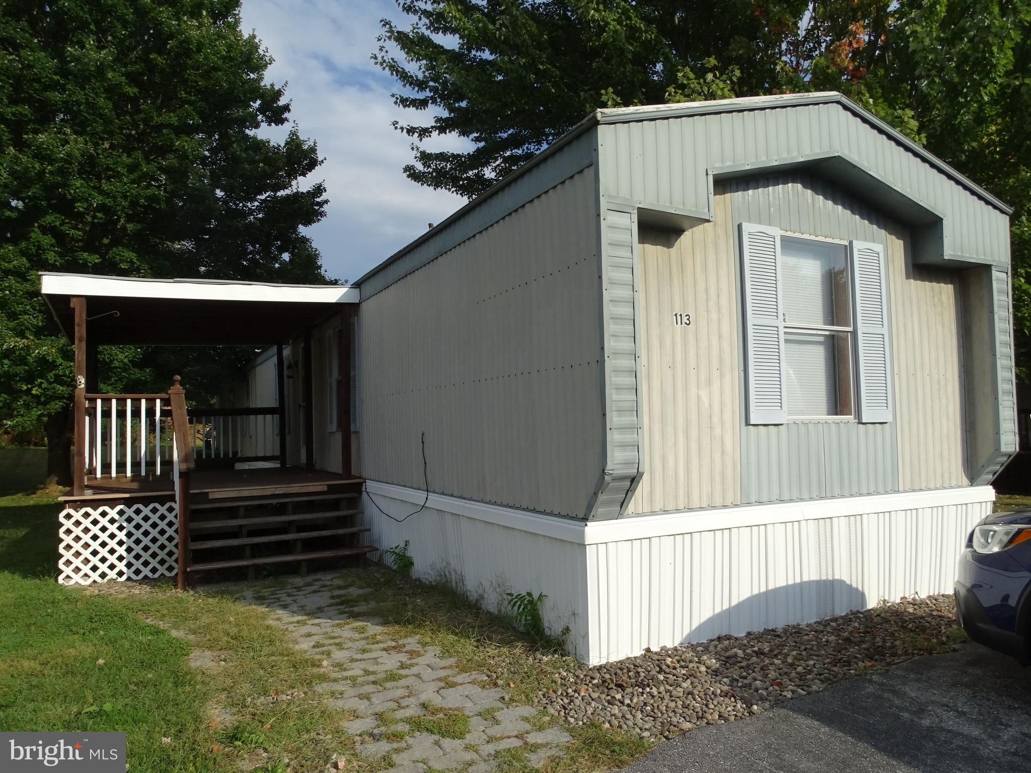 Morning coffee on this 10x12 covered front porch is just what you need! This 3 bedroom 2 full bath home offers an open floor plan to the living room that leads to a large eat in kitchen. Tons of storage cabinets including an overhead china cabinet. Some modern updates but always room for more. Home does feature a heat pump with Electric back up heating. Buyers will need community approval and no dogs permitted.