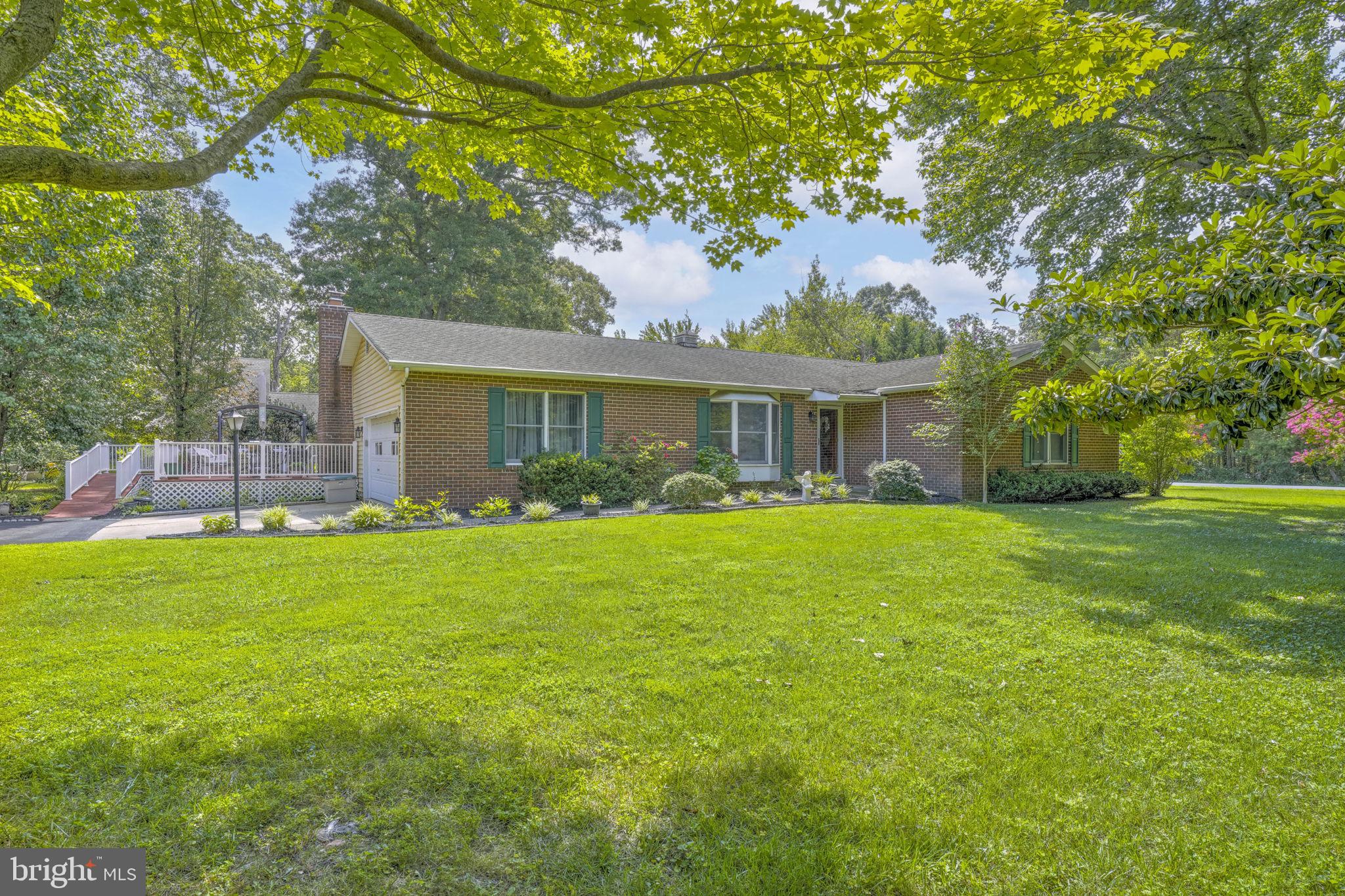 This spacious and well-maintained home offers the ease of one-level living at it's best. The modern kitchen opens to a cozy family room featuring a gas fireplace and a sliding door that leads to a stunning sunroom and adjacent deck—perfect for relaxing or entertaining. Enjoy formal spaces with both a living room and dining room, along with a generous primary suite complete with a private full bath. Two additional bedrooms and a second full bath provide plenty of space for family or guests. Additional highlights include a two-car garage, a two-car carport, a large storage shed, and a handicap-accessible ramp. Situated on a level, usable one-acre lot, this home combines comfort, functionality, and outdoor space in a peaceful setting.
