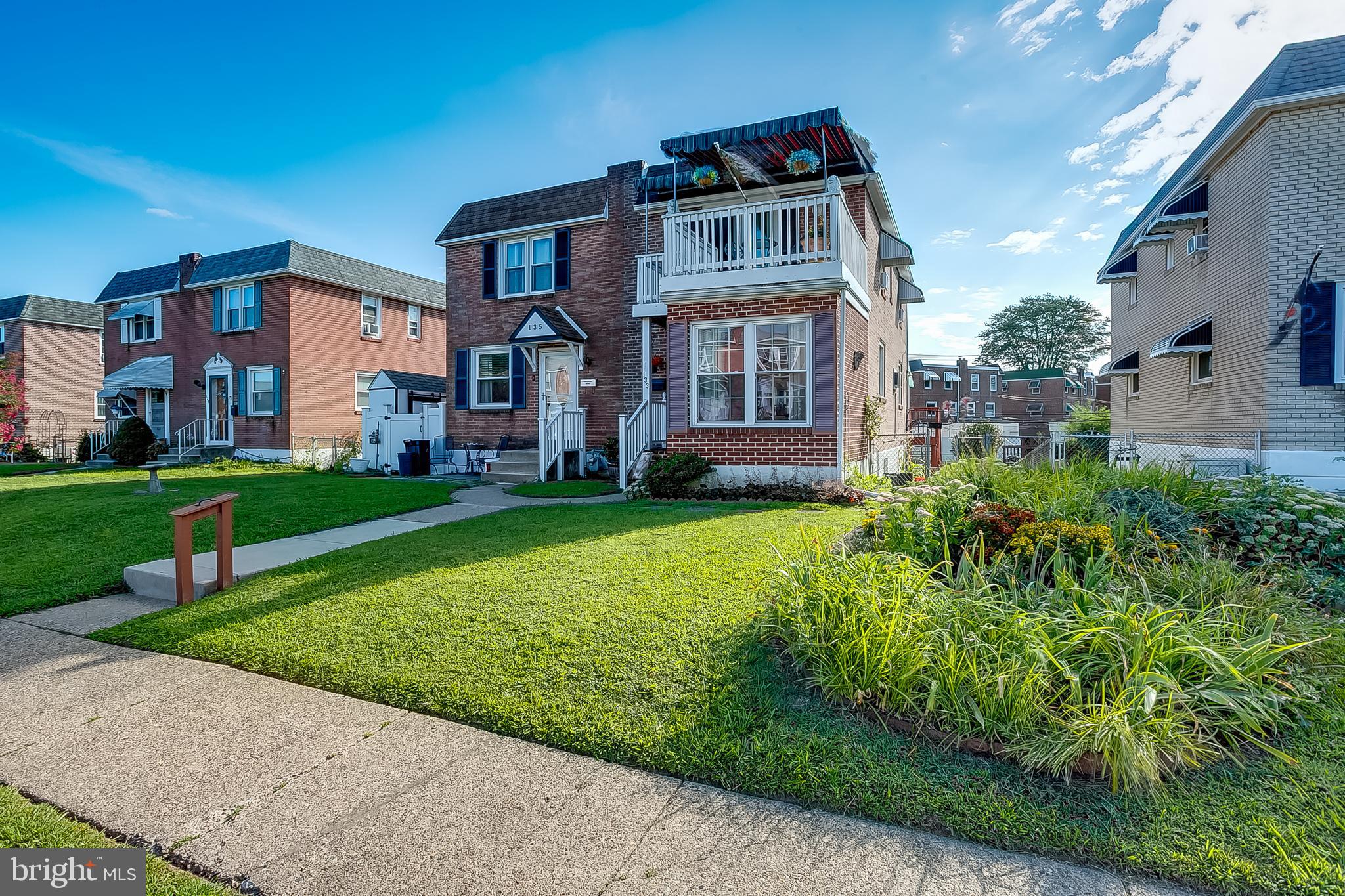 This charming 2-bedroom, 1-bath home is sure to capture your attention the moment you arrive. With its full brick exterior, bumped-out façade, and welcoming front deck with awning, this property blends timeless appeal with functional outdoor living. A concrete pathway guides you to the entrance, setting the stage for the warmth and comfort you’ll find inside. Upon entry, you’re greeted by a ceramic-tiled foyer complete with a coat closet, flowing into a versatile bonus room just off the front door. Whether you envision a cozy den, a home office, or a playroom, this space offers flexibility to suit your needs. The living room features an abundance of natural light and rich hardwood flooring, creating an inviting space for everyday living. Adjacent is the formal dining room, accented with faux-brick half walls, crown molding, and a ceiling fan. Hardwood flooring continues here, tying the two rooms together and providing a warm, cohesive feel. From the dining area, beautiful sliding wood doors open to a spacious rear deck with an awning, offering the perfect spot for summer barbecues or relaxing in the shade. The galley-style kitchen is both functional and bright, featuring gas cooking, a corner stainless steel sink, Formica countertops with tile backsplash, and an abundance of cabinetry for storage. Stainless steel appliances, including a built-in microwave and dishwasher, make meal prep and cleanup a breeze. A large window keeps the space airy and sunlit, while the extended counter space with overhead cabinets maximizes practicality. The primary bedroom is a true retreat, showcasing calming blue walls, plush carpeting, and its own sliding glass doors that open directly onto a private deck. Imagine stepping outside in the morning to enjoy the fresh air and peaceful surroundings before starting your day. The second bedroom is equally inviting, offering neutral carpeting, a ceiling fan, and a full wall of six-panel closets for excellent storage. The full bathroom combines comfort and style with ceramic tile flooring, a jetted soaking tub, a separate shower stall, a private commode, and a granite-topped vanity with pewter fixtures, a large mirror, and elegant lighting. The lower level of the home offers a full walk-out basement, perfect for additional storage and laundry space. This level also provides a convenient alternate entry point, ideal for leaving shoes and outdoor gear without disturbing the main living area. The property is complete with a one-car garage and a driveway that easily accommodates two additional vehicles. With not one but two outdoor decks, multiple living spaces, and a spacious basement, this home offers comfort, versatility, and curb appeal that truly stands out. Don’t miss the opportunity to make this exceptional property your own.