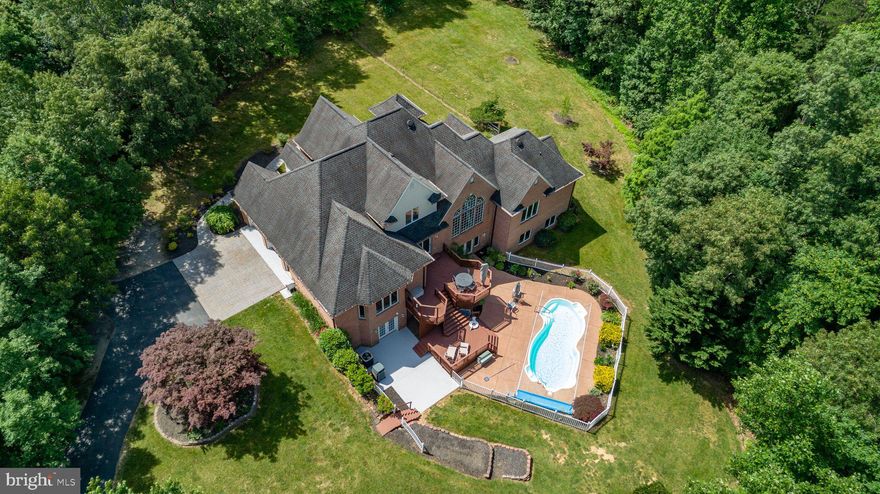 Summertime is here and now's the perfect time for you to get the house you've always wanted with an 
in-ground pool.  Fantastic over 6000 square foot all brick colonial on over three acres. As you come through the front door the huge great room with fabulous Brazilian cherrywood floors welcomes you home. As you make your way inside, the formal dining room is waiting for your next Thanksgiving dinner. The fabulous kitchen is loaded with extras.  The induction cooktop comes with a pop-up blower and one of the many cabinets has a mechanical mixer lift. There are two sinks, one at the center island  that includes a water filter and the other is a large carved granite farm sink. Wonderful stainless steel KitchenAid appliances including a wall mounted oven, a convection microwave, a built in French door refrigerator, granite countertops, breakfast bar, walk-in pantry and recessed lights.  The primary bedroom on the main level has a large walk-in closet, an ADA accessible bathroom with heated ceramic tile floors, instant hot water, two sinks, big soaking tub and a special shower enclosure.  The second bedroom on the main level has a full bathroom with ceramic tile floors and a great view of the backyard.  From the breakfast nook you can walk outside to the two-tier decks that will take you down to the pool.  The entire main level has zone controlled heated floors. The upper-level features two spacious bedrooms and one huge room/bedroom (ntc). The almost 3000sqft lower level
has a full bath and lots of open space.  In the basement you will notice this is a state-of-the-art insulated concrete form home. This is a safe, sustainable home that is energy efficient, comfortable and quiet.  
The oversized garage has plenty of room and tile floors.  The main features outside are the great pool with an easy to operate pool cover that keeps the pool clean, prevents evaporation and helps retain heat.  The large patio has plenty of space for chairs and tables.  The lot has a couple of added bonuses for you to enjoy.   Edible black and red raspberry bushes that make absolutely delicious jelly and along the front wooded perimeter area there some rare flowers called Lady Slippers.
Welcome home!!