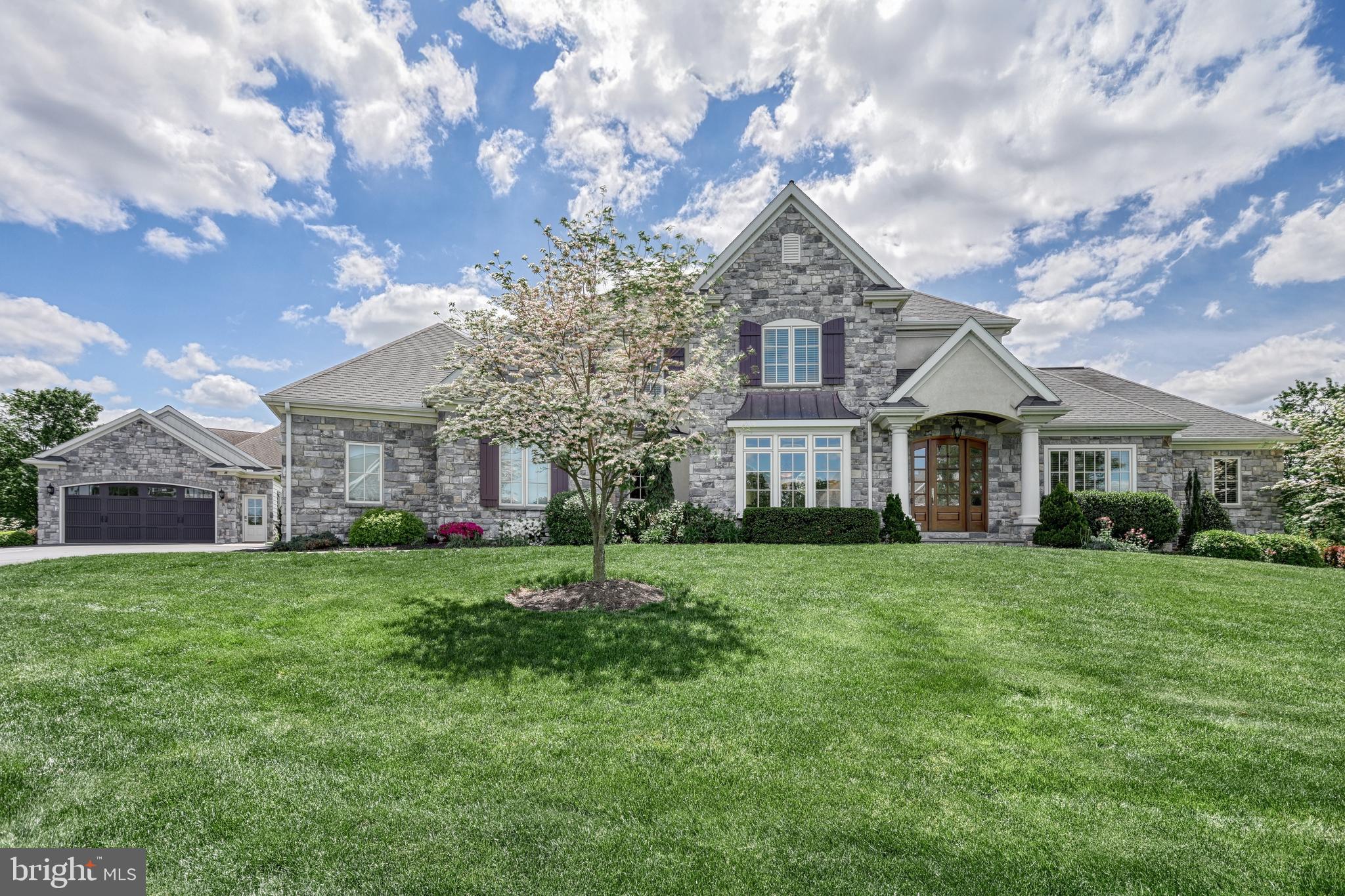 OPEN HOUSE CANCELED - Sorry for any inconvenience. Discover Braeburn Estates, an exceptional custom community in the heart of Central Pennsylvania. Convenient to Rt. 15 and PA Turnpike, this premier neighborhood is an integral part of the esteemed Smart Growth community of Winding Hills. Residents enjoy over 365 acres of preserved open space, complete with walking trails, woodlands, and integrated parks. The community's design features charming cobble roundabouts, sidewalks, and streetlights, all leading to a central social hub with a grand clubhouse, gym, and saltwater pool. Every detail of this custom home was considered with the utmost care for scale, function, and beauty. The timeless character and unsurpassed quality is evident. From the curving slate walkway to the striking portico with elegant pillars, you will notice you are about to enter a home that exemplifies distinction. Soaring two story foyer, turned volute staircase, and wrought-iron spindles lead you to an impressive great room boasting 12-foot ceilings, custom-built bookshelves, a distinguished fireplace with a Samsung Frame TV, and a striking wall of windows that fills the space with natural light. The main level showcases elegant architectural details; including lighted tray ceilings, crown molding, shadowbox, custom profile trim, and beautifully cased arched openings. The gourmet eat-in kitchen serves as the heart of the home, featuring luxurious leathered granite countertops, top-of-the-line Thermador appliances, a custom stone backsplash, a custom hood, a warming drawer, a hidden walk-in pantry, a large center island with prep sink and overhang. Just off the kitchen is the formal dining room with plush window seat. The den sits quietly off the foyer behind French doors. The first-floor owner’s suite provides a tranquil retreat. The sitting area has direct access to the rear deck. An opulent spa-like five-piece bath. Palatial separated vanities span two walls. The tile walk-in shower features a viscy rain shower and tile bench, and the relaxing corner jetted tub is framed by windows with gorgeous plantation shutters. Two enormous walk-in closets. Upstairs, there is a generous landing that connects three additional spacious bedrooms. An ensuite and a hall bath with double bowl vanity and linen closet. The owner entry offers built-in storage nooks, roll out filing drawers, shelves, and a seat with storage underneath. Off the entry is a large laundry room with built-in folding table and base cabinets, drying rack for hanging clothes, and a built-in wash basin with base cabinets. The powder room has a granite top and Kohler cast iron undermount sink. The exposed walk-out lower level is an entertainer's dream, complete with a custom bar area, an impressive wine cellar, a spacious rec room with a built-in media center, a private gym, a full bath, and abundant natural light. The beautiful setting for this gorgeous home offers a perfect blend of indoor and outdoor living. Enjoy a beautifully landscaped corner homesite, an expansive composite deck, and a lower-level patio, providing endless possibilities for outdoor entertainment. The screened porch offers a perfect spot for reading or unwinding. Additional highlights of this remarkable home include energy-efficient gas heat, three zones of heating and cooling, gas hot water, water softener, radon mitigation system, 400 amp electric service, generator, and a superior wall foundation ensuring lasting durability and comfort. Car enthusiasts will delight in this rare five-bay garage. Three cars side entry, two cars detached. Located within Upper Allen Township and served by the highly-regarded Mechanicsburg Schools, this home offers a perfect fusion of luxury, comfort, and thoughtful design. I encourage you to schedule your private showing today to truly experience all that this exceptional property has to offer.