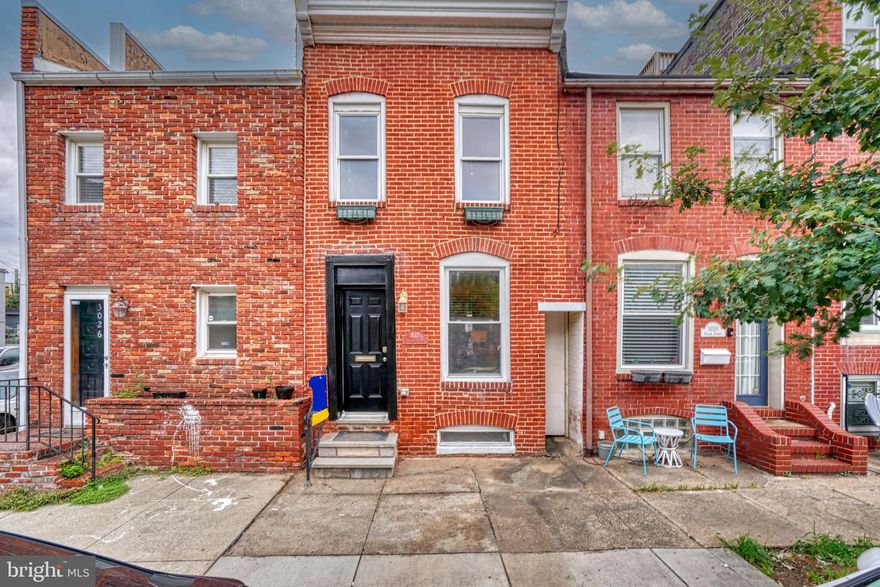 Welcome to 3028 Dillon Street--the one that checks all the boxes. This charming 2 story brick rowhouse circa 1910 is just two short blocks to Canton Square and the waterfront. You enter into a wonderful open concept living room and dining room with lovely warm patinated wood floors and custom millwork. Even though you are just steps from some of the best restaurants in Baltimore, you may just want to say home and cook in your updated kitchen! Just beyond the dining room, it has acres of counter space, tons of cabinets and stainless steel appliances. At the back of  the kitchen is a first floor laundry room with additional storage. The second floor has two bedrooms. The primary suite  is located at the front of the house and has exposed brick walls, great closet space and access to an en suite full bathroom. The full bathroom has been updated with a wide vanity, tiled floors and a large shower and soaking tub.  Moving to the back of the house, you will find another full bathroom with a large shower and a rear bedroom with great closet space and tons of natural light. Don't miss the 2nd floor entrance to an incredible 2 tiered roof deck with terrific views of the city skyline. Last but not least is your own parking pad! This one is not to be missed!