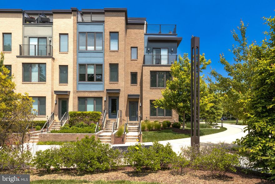 Welcome to this spectacular 4BR/3.5BA corner unit townhome, located in the highly sought-after Montgomery Row. The Ellis, one of only 5 originally offered in the community, features distinctive modern style with expansive living space that flows through four levels. With 9’ ceilings, the main floor combines a spacious living & dining room with hardwood floors and a centrally located gourmet kitchen with granite countertops, stainless steel appliances, 42" maple cabinets and a huge 11 ft. island.

Retreat upstairs to the sophisticated bedroom level where you’ll find a large primary bedroom that boasts two large walk-in closets, one with custom built-ins and a separate linen closet. The primary bath features an elegant frameless glass shower, marble bench seating, and dual sinks. Two remaining bedrooms are both bright and spacious, both with ample walk-in closets. An additional full bath and a conveniently located laundry room, with full size washer and dryer, complete the upper level.

The top-level steps out to a private 669-sq. ft. rooftop terrace with space for both lounging and dining. A gas fireplace, wet bar and a retractable awning create the perfect retreat for entertaining and relaxing throughout the seasons.

The entry-level in-law suite can be used in a multitude of ways. The space pairs a sleeping area, recently used as a gym, living area, full ensuite bath and wet bar. All this plus heated marble floors on the entry level, a large 2-car garage, central vacuum throughout the home, custom window treatments and plenty of storage!

Montgomery Row’s location, close to I-270/I-495, positions your home perfectly for quick access to shopping at Montgomery Mall, Wildwood, Balducci’s & Giant. Within close proximity to Bethesda and 355 brings everything you need right to your doorstep. You can head to Cabin John Park for the dog park, ice skating, tennis, and trails. Downtown Bethesda brings plenty of must-try restaurants and nightlife options. Minutes to Grosvenor Metro and nearby public transportation provide convenient commuting options. You really can have it all!