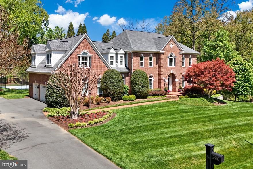 Stately 3-sided brick home in the coveted Colvin Mill Run neighborhood in Great Falls.   Guests are greeted by a landscaped brick walkway and an elegant curved brick portico.   A welcoming foyer is accented by a captivating wrought iron balustrade and formal living and dining rooms.  Exceptional kitchen renovation with Subzero, Wolf, and Miele appliances.  Entirely reconfigured with a truly elevated design.  Centered by a statement island that encourages gathering and flows seamlessly into the breakfast room.   An adjacent butler's pantry is equipped with a wine &  beverage fridge + a second bar fridge making entertainment a breeze.   Fall in love with the breathtaking family room which features a stunning coffered ceiling and stone fireplace overlooking a private treed backyard.   A well-designed home office has an adjacent family powder room and rear staircase.  Step out to a “Southern Living” screened-in porch and deck for summer evenings and cookouts.  Enjoy easy access to the lower patio, backyard and Sport Court - perfect for pickleball or basketball.  Sophisticated primary suite with a custom tray ceiling and a delightful sitting room enhanced by a gas fireplace and built-ins.  A light-filled walkway leads through to a dressing area, vanity, 2 walk-in closets and a fully remodeled luxury spa bath for the perfect retreat.  The secondary bedrooms are situated along a private hallway which can easily utilize the rear staircase.  You have a large bedroom with an en suite bathroom and a nice walk-in closet.   Additionally, you have 2 charming bedrooms that share a buddy bath and feature dormer windows and an inviting window seat with storage drawers in the rear bedroom.  Plus, a convenient upper-level laundry room.  The walkout lower level club room features a full bar (originally located at the Great Falls Irish Brogue pub!) w/kegerator and glass shelving.   A cozy theater room awaits with a stone fireplace, built-ins, and fully upgraded media equipment - perfect for movie nights or the sports enthusiast!  Additionally, you have an en suite guest bedroom (shown as a gym room) with a dual-entry bath.  Plus, a large  storage room with built in-shelving (free-standing shelving can convey, if desired).  This magnificent home also features a 3-car garage complete with wall organizers, garage floor coating, and Hi-Speed electric car charger.  Updates throughout the home include: HVAC zone 1 - 2015, HVAC zone 2 - 2016, Gym Room - 2016, Master Bath - 2018, Hi-Speed Electric Car Charger - 2019, Kitchen Renovation - 2021 w/Subzero Refrigerators, Wolf oven, Miele dishwasher, Garage Floor coating and wall organizer - 2023, New Roof - 2024, New H20 Heater - 2024, New Garage Doors (all) - 2026