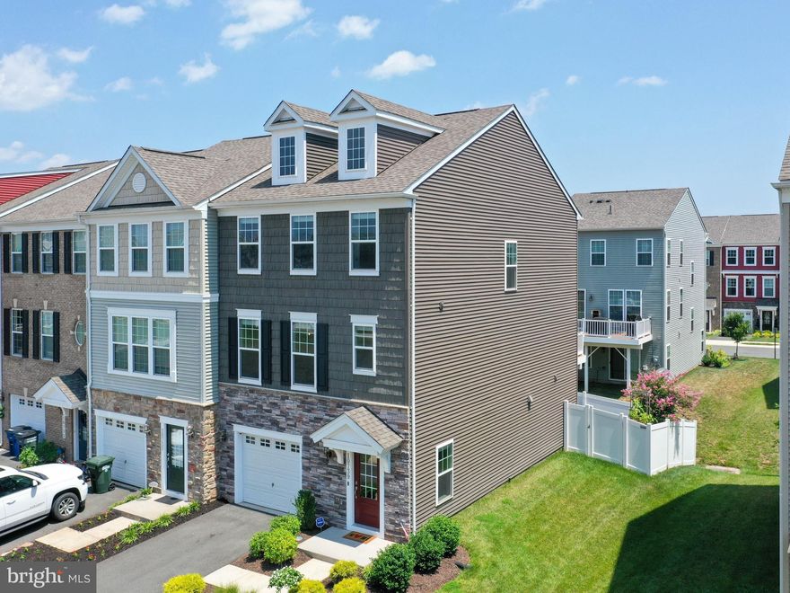 This is the home for you in Bradley Square, located just 8 minutes from the VRE & downtown Manassas! Enhanced both inside and out, this sophisticated and meticulously maintained 2,300 sq ft townhome is sure to impress. Take in the rest of summer from the functional backyard featuring a multi-level, partly shaded paver patio with vinyl privacy fence, plus a deck with vinyl railing on the main level. Both the first and second floors have engineered hardwood floors throughout. You’ll also find lots of recessed lighting, tasteful paint colors, and tall ceilings that make each room feel spacious and bright. The entry level features a grand foyer, versatile bonus room or potential 4th bedroom with full bath, access to the backyard, and a single-car fully finished garage with epoxy floor and built-in storage. The open-concept main floor has a designer kitchen with granite counters, island seating, double oven, pantry, and stainless steel appliances. The dining area and family room flank the kitchen, creating an open and comfortable living space. Upstairs are 3 bedrooms and the laundry facilities that will convey. The generously sized primary bedroom suite features his/her walk-in closets, recessed lighting, and an en-suite bath with a luxurious tile shower and double sinks. The two additional bedrooms on this level offer ample closet space and easy access to a well-appointed full bathroom. This home overlooks the community common area with green space and a pavilion for outdoor entertaining. Other neighborhood features include walking trails, an outdoor exercise area, splash pad and playground for the littles, community activities like movie nights, Easter egg hunts, etc., and plenty of extra parking. HOA dues include trash/recycling and landscaping. Shopping and dining options are plentiful around the area, plus the City of Manassas hosts events year-round including street fairs, farmers market, and holiday parades. This home is within walking distance to Bennett Elementary and provides easy access to I-66, PWC Pkwy, 234, and I-95. There’s so much to love about this stunning, like-new property that you won’t want to miss!