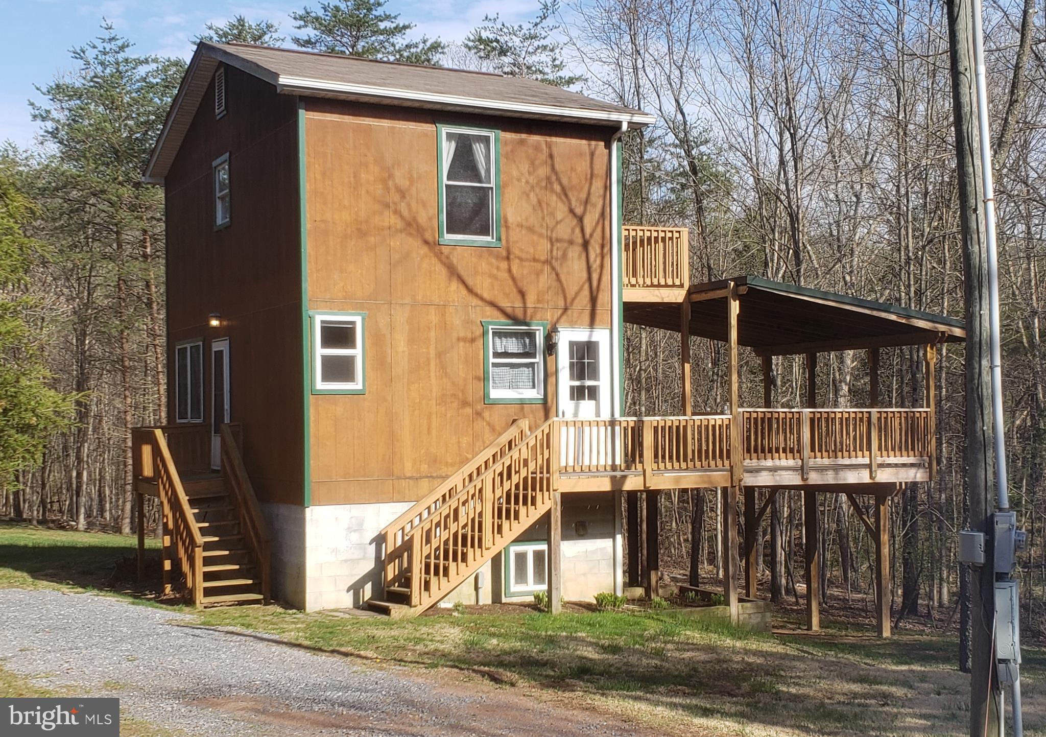 Cozy week-end retreat or full time residents located in desirable gated river front community. Well maintained roads. Peaceful and private setting. Large deck great for entertaining or just relaxing. Stream runs through the property, wooded and open, enjoy the wild life. Views out every window. Two generously sized bedrooms.Beautiful bamboo flooring. Conveniently located just 40 minutes to Winchester, VA. Conventional gravity fed septic system for 3 bedrooms, HVAC system will support a much larger house. Property originally build with the intention of adding on additional living space.