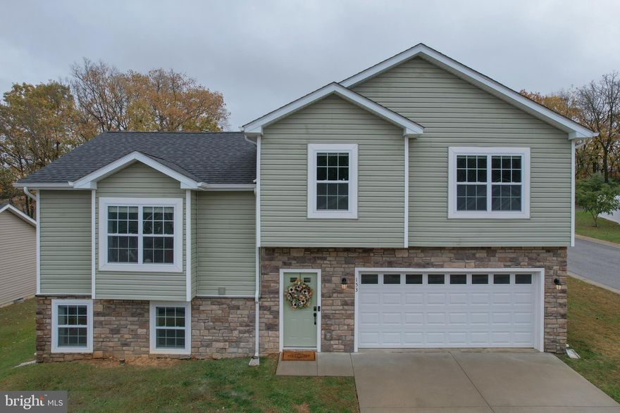 Come and see this Move-In Ready Split-Level Home with 3 Bedrooms, 3 Baths,  Built 2019 conveniently located in Inwood, WV.

Why wait for new construction when you can have like-new right now? Built in 2019 by a reputable local builder known for enduring quality, this beautiful split-level home blends modern design with everyday functionality—set on a corner lot in a peaceful community just minutes from Inwood conveniences.

Step inside the tiled entry foyer, where a spacious laundry room and access to the two-car garage make day-to-day living effortless. The fully finished lower level features a large flex room with natural light, plus a full bathroom with walk-in shower and vanity—perfect for guests, hobbies, or multi-generational living.

Upstairs, the open-concept main level boasts luxury vinyl plank flooring, fresh paint throughout, and an inviting kitchen with granite countertops, island with bar seating, soft-close white cabinetry, and stainless steel appliances. Sliding doors lead to a deck overlooking the backyard—ideal for relaxing or entertaining.

The upper level offers three generously sized bedrooms, including a primary suite with tray ceiling, double closets, and a private ensuite bath featuring a walk-in shower and double vanity. Two additional bedrooms provide ample closet space and share a bright hall bath.

Additional highlights include new carpet throughout bedrooms, a power-washed exterior, and blinds that convey. Enjoy country views while staying close to commuter routes, shopping, and schools—this Arden Nollville area gem offers the best of both worlds.