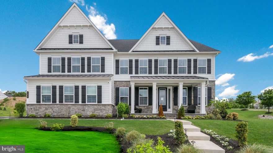 Welcome to 143 Adrienne Court, an extraordinary residence in Greystone, West Chester’s premier community known for its scenic rolling hills, sidewalks, and over seven miles of walking trails—all just minutes from the heart of the Borough. This former model home is the epitome of luxury and convenience, fully furnished with every detail carefully curated, including all furniture, window treatments, and décor. As you arrive, professional landscaping, a mix of stone, hardiplank & siding exterior and a charming bluestone front porch with a metal roof create a stately first impression. Step inside to find soaring 9-foot ceilings and 8-foot doorways that enhance the sense of grandeur. The formal dining room sits to the left, while a stylish home office with French glass doors is to the right. Moving forward, the home opens into a breathtaking two-story great room, flooded with natural light from a wall of windows and anchored by a floor-to-ceiling stone gas fireplace and coffered ceiling. Designed with modern lifestyles in mind, the open floor plan flows seamlessly into a chef’s kitchen that is both stunning and functional. It features a large center island, farmhouse sink, exposed stainless steel hood, and a six-burner GE Café Advantium range with dual ovens and a convection microwave. Carrera Gold Quartz countertops, a pot filler, beverage refrigerator, and a custom tile backsplash complete the space, along with abundant cabinetry. Just off the kitchen, you’ll find a well-appointed butler’s pantry and a custom-designed arrival center with built-in bench seating and hooks—ideal for organizing everyday essentials. Throughout the first floor, wide luxury vinyl plank flooring adds both durability and elegance. Also on the main level is a private guest suite with a full bath and walk-in closet, as well as a separate powder room for added convenience. Ascend the oak staircase with white balusters to the second level, where the hallway overlooks the dramatic great room below. The primary suite is a luxurious retreat with a tray ceiling, sitting area, recessed lighting, and two expansive walk-in closets. The ensuite bathroom offers a spa-like experience with dual vanities with Quartz counters, a freestanding soaking tub, and a large shower enclosed in frameless glass, all finished with upscale ceramic tile. Three additional bedrooms each feature their own private baths and walk-in closets, while the upstairs laundry room provides both convenience and functionality. The finished lower level is designed for both entertainment and relaxation, with a large open area perfect for gatherings, a dedicated gaming room with dual TVs, and an additional bedroom and full bathroom. A walk-up stairwell with French glass doors allows for easy outdoor access. Step outside to a stunning covered porch with composite decking, recessed lighting, and a stone fireplace complete with a mounted TV, making it the perfect spot to unwind or host guests. The backyard offers privacy and serenity, along with a generous side yard ideal for play and outdoor activities. Additional features include a tankless hot water heater, dual HVAC systems, and a waterjet backup sump pump for peace of mind. Conveniently located near major routes including 202, 100, and 322, this move-in ready home offers immediate occupancy and a lifestyle of comfort, elegance, and ease. Schedule your private showing today and experience the unmatched charm and sophistication of 143 Adrienne Court. This is more than a home, it’s your next chapter.