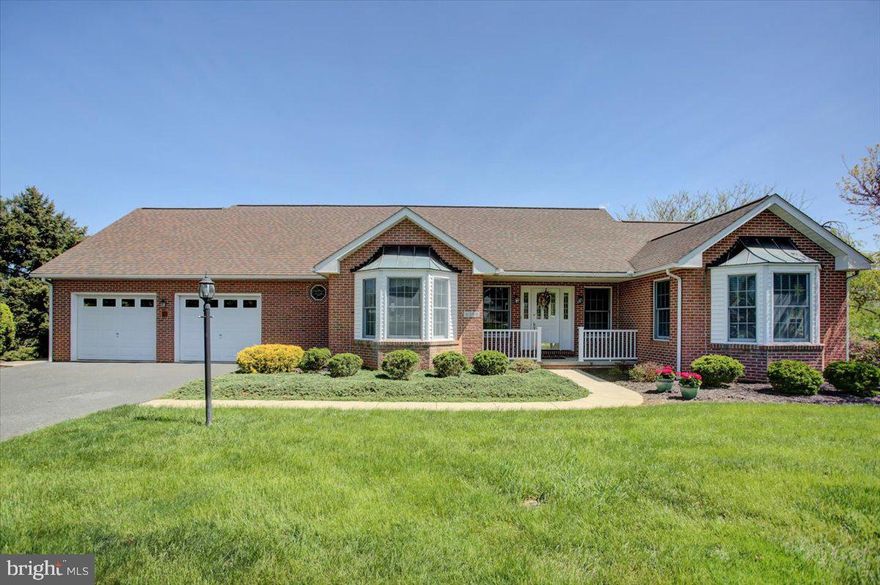Offered for the first time since it was built, this thoughtfully crafted custom home sits on a double lot, where mature landscaping frames panoramic mountain and valley views. Watch horses roam peacefully in the distance as you sip your morning coffee from the fully screened back porch—an elevated composite retreat complete with lighting, ceiling fans, and walkouts from both the kitchen and living room through French doors, plus a staircase that leads gracefully down to the yard below.

Every inch of this home reflects quality and intention. Built with expert masonry, steel beam construction, Andersen windows, extra insulation, and a dedicated panel box for hobbyists or tinkerers—no expense was spared in the making of this forever home.

The heart of the house is an open and airy floor plan, where natural light spills through oversized windows onto warm maple floors. The kitchen, a dream for any cook, features custom cabinetry, quartz countertops, and a high-end gas stove ready for your favorite meals. A charming office with built-in cabinetry sits just off the kitchen, and a spacious laundry room with a deep utility sink adds everyday convenience. The home is also equipped with a central vacuum system for effortless maintenance and day-to-day ease.

The private owner's suite feels like a sanctuary, complete with a beautifully updated bath and views that never get old. Two additional bedrooms and a full bath are thoughtfully positioned in a separate wing, offering privacy and comfort for guests or family.

Downstairs, the walk-out basement opens to the backyard and features a large finished room for whatever your heart imagines—fitness, art, media, or entertaining. There's also a handy-room with built-in cabinetry for projects and crafts, a half bath, and ample unfinished storage space.

This is timeless living at its finest—where craftsmanship, thoughtful updates, and breathtaking surroundings come together in one of Penn National’s most coveted settings.