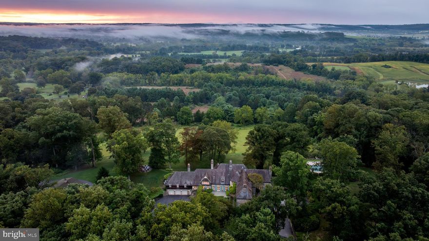 Live authentically. Sunny Hill Farm circa 1937. Brilliantly designed by William McMillan, storied architect. McMillan was also commissioned locally to design Alfred Vanderbilt's residence at Sagamore. McMillan married Grace G. Roosevelt, granddaughter of Theodore Roosevelt. They lived their days out at Sunny Hill. This is the second time it has been offered. A significant estate perched on 261 glorious acres with spectacular panoramic views of Worthington Valley. Masterful architecture. This English Country estate was sited in a way that dances with the sun. Your sense of arrival is punctuated by a very purposeful Moon Gate. I can only imagine an architect who is just as avid of a yachtsman would incorporate such a feature to connect with a framed view of the cosmos. Remarkable. Poetic interior and exterior courtyards grace every space. Soothing fountains are placed just so. Artistically framed views abound. Dazzling use of expansion and contraction. Sunny Hill will have a profound effect on you. A place to be cherished for generations. A cultivated trail network exists... adventure through vast woodlands, streams, orchards, and rolling farmland. You will experience microclimates from one end of the property to the other. Teeming with wildlife. Stroll seamlessly into the great outdoors and never miss a sunrise or sunset from one of your many terraces. Exquisite pool and hot tub. Ample space to curate pasture and equestrian facilities if desired. Greenhouse. Amish built five bay barn. Additional potential densities. Cultivate your existence. The art of uniting human and home.