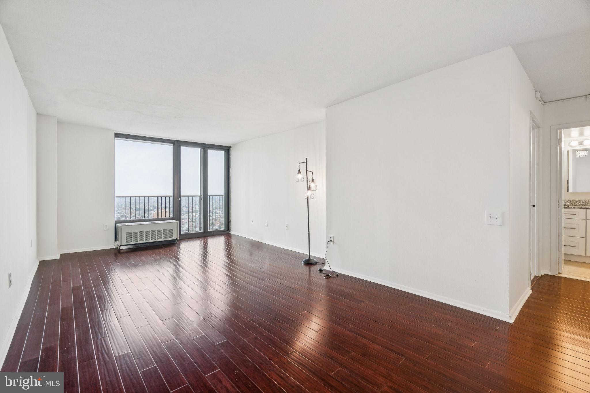 Updated, south-facing one bedroom with a private French balcony on a high floor of Academy House. Enter through a foyer with coat closet into the sun-soaked great room with dark vinyl floors, ample space for living and dining, and floor-to-ceiling windows that lead to the private balcony with see-forever southern views. The renovated kitchen offers white shaker cabinetry, granite countertops, stainless steel appliances, and a tile floor. The spacious bedroom enjoys oversized windows and excellent closet space. The nearby hall bathroom has an oversized white vanity with granite top, tub shower with designer tilework, tile floor, and a laundry closet with stacked washer/dryer. There is excellent closet space and natural light throughout. Residents of Academy House enjoy a 24-hour doorman and a state-of-the-art fitness and aquatic center. There is valet parking in the building's garage for an additional monthly fee, subject to availability. The Academy House is located in the heart of Center City and within close walking distance to Rittenhouse Square, Washington Square, and the Broad Street and Market Street office corridors. The Philadelphia International Airport and Amtrak's 30th Street Station are easily accessible.
