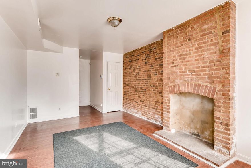 Ideal property for first time home purchaser or entry level investment home.  Built on a slab, enter into the living room with exposed brick walls and decorative fireplace.   Follow hall past utility closet which houses gas furnace and gas hot water heater.  There is also a guest closet within the living room.  Follow hall to sizable eat in kitchen, with side entrance to petite side and rear yard.  There is also an outbuilding at the rear of the property for storage.  Second level front sitting room flooded with light, Hall with staircase to second level, hall bathroom and bedroom at the rear with hook up for washer/dryer.  Second level features two bedrooms.  Certified lead free property.  Home inspections are certainly welcome for informational purposes only.  Convenient walk to Hollins Market, the business district, downtown Inner Harbor and both stadiums.  Located on the bus line.  Ideal for U of Md affiliate and qualifies for live near your work program for U of Md affiliates.   Ground rent exists; however, owner has never received a bill.  Sold "as is".
