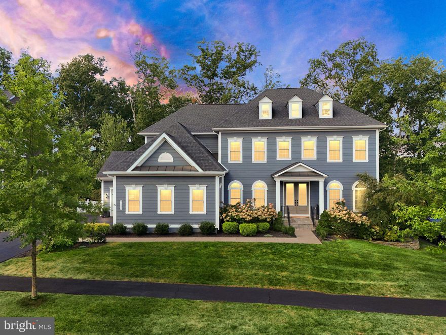 Welcome to your dream home in Willowsford – The Grange, one of Ashburn, VA’s most prestigious and picturesque communities!  Tucked away in a quiet cul-de-sac, this East-Facing Regents Park II by NV Homes is the ultimate blend of luxury, comfort, and thoughtful design. From the moment you step inside, you’ll feel the warmth of a truly special home—a place where every detail has been curated to inspire joy, relaxation, and effortless living.

Upstairs, you’ll find five spacious bedrooms, each with its own en-suite bathroom, offering comfort and privacy. The convenience of an upper-level laundry room makes everyday living even easier.

The primary suite is a warm and inviting retreat, complete with a tray ceiling and the spa-like bathroom offers an oversized walk-in shower, dual vanities, ample storage and luxury finishes that make every day feel like a getaway.

At the heart of the home is the gourmet kitchen, where style meets functionality. Luxury cabinetry, sparkling countertops, a center island with two dishwashers makes clean-up a breeze, and an extensive second island with even more storage and wine fridge make it the perfect place to gather. A bumped-out breakfast room, formal dining area, and expansive family room with coffered ceiling, built in bookshelves and a beautiful flagstone gas fireplace extending to the ceiling.  The enormous picture window brings the outdoors in, filling the home with natural light and scenic conservancy views.  Continuing on the main level, a versatile room offers the perfect opportunity to created a main-level bedroom.  With minimal modifications, it could be transformed into a bedroom with an ensuite, adding convenience and flexibility to the home's layout.

Hardwood floors flow throughout the entire first floor and master bedroom, while a dedicated office with French doors and custom built-ins ensures a perfect work-from-home retreat. Thoughtful touches like a double staircase, butler’s pantry, mudroom, and custom trim work highlight the craftsmanship throughout.

The walk-out entertainment level is any host’s dream: a full bar extending nearly the width of the room, glass paneled cabinetry, a beverage fridge and the home’s third dishwasher comprise this amenity, all in view of the custom-built decorative wall with built-in TV for viewing all the games and movies your guests might desire. Underneath is a gorgeous, near eight foot wide fireplace, providing not only a beautiful ambience, but additional warmth in the winter time as well. Rounding out the entertainment level are the private gym, additional generous recreation space, and sixth bedroom with full en-suite bath, making overnight guests feel like they’ve checked into a resort.

Step outside and instantly feel like you’re on vacation. Your private heated saltwater pool and mahogany wood surrounded-spa with waterfall feature create a luxurious resort atmosphere, complete with elegant travertine decking. Surrounded by the peaceful beauty of the Willowsford Conservancy and over 35k in landscaping and uplighting, the backyard feels like a private sanctuary—perfect for both hosting large gatherings or taking time for solitude with a bit of swimming, lounging, or simply enjoying the sounds of nature.

Living in Willowsford – The Grange means access to award-winning amenities, scenic trails, farm-to-table lifestyle perks, and a strong sense of community. Combined with your home’s private Conservancy views and resort-style features, it’s a lifestyle that truly feels like a permanent vacation surrounded by nature.
