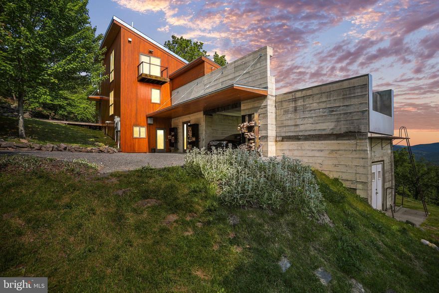 Located just two hours from the DC Metro area in the heart of the sought-after Lost River, this spectacular, architecturally significant home has an unmatched “mountain modern” aesthetic and was custom-built to exact specifications where no detail was overlooked. Perfectly sited on 6+ acres, this home features four bedrooms, two full baths and two half baths thoughtfully situated on three levels.  This home is completely turn-key and offered fully furnished.  The exterior architecture incorporates traditional tongue and groove cedar siding contrasted with organic board-formed concrete. This home is perfect for every purpose, the captivating, sweeping panoramic long-range mountaintop views create an idyllic atmosphere for spending quiet moments in peace, entertaining guests, and telework. 

Upon entering the home through the 2-story foyer, the overwhelming, expansive view of the Lost River Valley and surrounding mountaintops are framed by two stories of floor-to-ceiling glass and windows. The great room with pine-clad soaring ceilings and exposed beams are filled with and anchored by a beautiful Rumford-style wood-burning fireplace. The dining room is surrounded by walls of full-glass French doors, and features hidden retractable screens, creating an indoor/outdoor dining room. Just outside the dining room, an unmatched atmosphere is created on the stunning elevated entertaining deck which has been artfully designed with a jaw-dropping stainless steel, heated, infinity-edge pool looking onto the panoramic valley views, integrated audio system, an outdoor gas fireplace and outdoor kitchen with integrated professional gas grill. All exterior decking is extremely dense Brazilian Ipe wood that is extremely long-lasting and naturally nearly maintenance-free.

A beautiful and functionally designed gourmet kitchen perfect for creating meals of any size features a very large center island with bar-height counter and seating, stainless steel countertops, a gas cooktop, a seamless built-in cabinet front refrigerator, and Gaggenau built-in coffee and espresso machine. The loft, ideal for telework, overlooks the great room, takes in all of the expansive views, and features a Juliet balcony overlooking the grounds and a half bath. This large space can also serve as an additional bedroom, den, or library.

An entire west-facing wing taking advantage of the vast views features the primary bedroom suite with an incredibly efficient wood-burning Rumford-style fireplace, large ensuite bath, walk-in closet, secluded outdoor shower surrounded by a natural rock waterfall, and private deck that is perfect for reading and meditation or afternoon naps in nature. The lower level features a wine cellar, a full bathroom with jetted Jacuzzi soaking tub, and three bedrooms each with views and direct outside access to a beautiful deck and the expansive lawn and meadow below. One bedroom is currently set up as a home gym. Also on this level a traditional Finnish sauna is perfect for post-workout.

There is also an existing art studio/workshop with a private exterior entrance and glass French doors that open to the view and lawn, it features a double sink and has already been rough-plumbed and can be easily converted into another bedroom with an ensuite bath.  

This property is served by high-speed fiber optic internet and all underground utilities. Nearby entertainment & shopping - approximately one mile to the Guesthouse Lost River (on the same street) and within a few miles of nearby local markets, shops & businesses.  The Lost River State Park and George Washington National Forest just a few miles away feature thousands of acres of hiking trails, horseback riding, and more.

Visit the Virtual Tour & Video-Walkthrough links to see this incredible home!