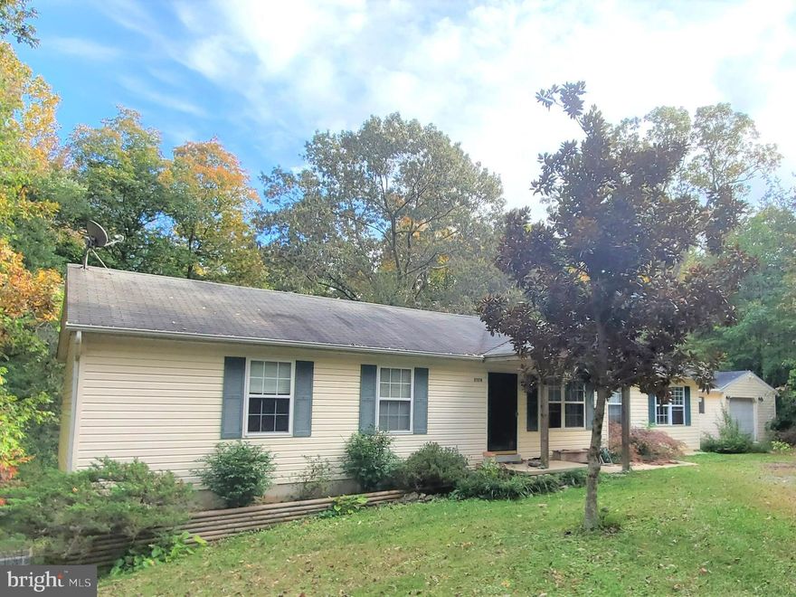 Check out this nature lover's delight!  Sited on a 1.61 acre wooded lot, this well-kept ranch style home is located in a quiet neighborhood with no HOA and backs up to approximately 20 wooded acres of community common space.  The home offers 3 bedrooms, 2 full bathrooms, and an attractive open concept floor plan.  Enter the home from the covered front porch onto the lovely laminate flooring and you're welcomed by an open dining and kitchen area, the perfect place to gather while preparing or enjoying a meal or game night.  The kitchen is fully equipped and features a large pantry and laundry closet.  From the kitchen you can access the custom 2-tiered deck where you will spend many hours relaxing while enjoying gorgeous wooded views and the sounds of nature.  Adjacent to the kitchen is a Texas-sized family room, complete with a custom built floor to ceiling stone hearth, topped off with a wood stove, ceiling fans, beautiful laminate flooring, and a large picture window.  With the wood stove keeping you cozy during those chilly days or nights, this is the ideal place to create those magical memory making moments as you're taking in a movie or curling up to read a book.  From the family room, you also have access to the deck where your wood will be stored so you can keep the stove stoked.  Down the hallway, on the other end of the home, you will find 2 bedrooms and a full hall bath with tub/shower combo.  Additionally you will find the owner's suite with double closets and a full bath with a tub/shower combo.  For the budget and energy conscious homebuyer, you will be delighted to know that an array of solar panels, which are wholly owned by the seller, convey with the property.  That's right, there is no Purchase Power Agreement to sign and no extra monthly payments to make to a 3rd party company.  The best news is that your electric bill will be ridiculously low.  The seller even receives an energy credit on a quarterly basis because of the energy the system creates.  You'll also be happy to know that there is a recently replaced heat pump that is still under warranty.  For the hobbyist, craftsman, mechanic, gardener, or the like, there is something for all.   There is a garage-sized workshop, with electric, an open front garage/shed, with an attached storage shed on the back, and another utility shed, great for storing equipment or garden tools.  The utility shed is located next to a garden area.  If you like red raspberries, there is a large patch of those next to the deck, as well.  The patch has yielded enough berries to can a batch of jam every year.  There is a little bit of blackberry there, as well.  We mentioned the large wooded community space that the property backs up to, but let us not forget to mention the community pond.  This truly is a beautiful, one-of-a-kind property.  Don't miss your opportunity!  Call us TODAY to schedule your private tour!