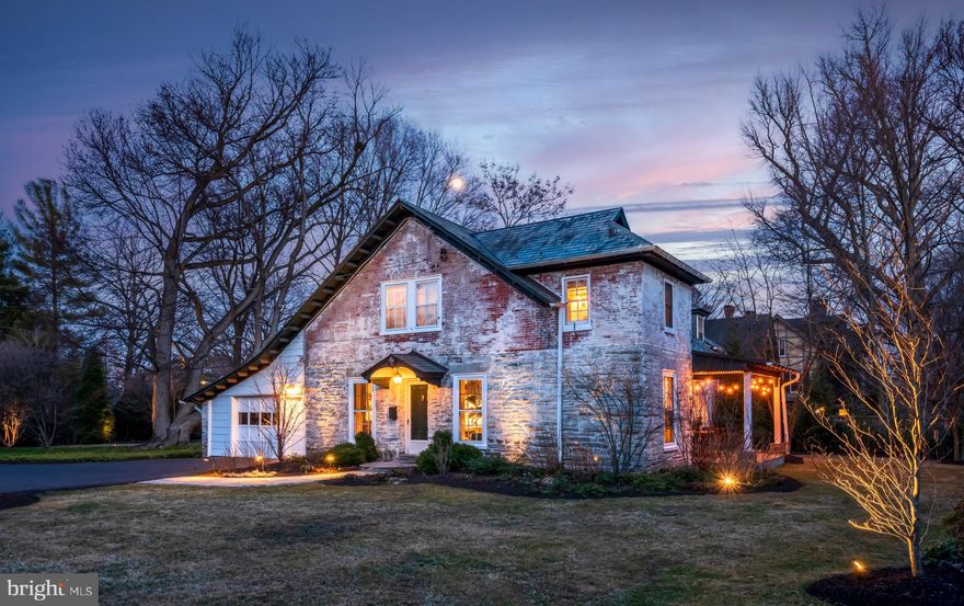 Charming Brick and Stone Carriage Home
Originally part of the five-acre Woods Estate, this lovely home sits on a private half-acre in a park-like setting. Entering through the wood gate, a long private driveway brings you to the house, which sits back from the road. Meticulously landscaped with specimen trees and shrubbery for even more privacy, this converted carriage house reminds you of the English Cotswolds with its slate roof and painted stone and brick. Gleaming hardwood floors greet you as you enter the spacious living room. The large windows with deep sills, built-in bookcases, and wood-burning fireplace will make you want to linger and relax in this serene space. Off the living room, a cheerful half bath with a coat closet is available for guests. A French door leads to a secluded and private covered porch where you will enjoy your outside meals in a peaceful bucolic setting, and an archway leads to the large sunlit dining room where you can entertain family and friends. 
Next, enter the brand new, gorgeous butler's pantry and kitchen. Well-thought-out and beautifully designed, the speakeasy-style butler's pantry features soapstone countertops, double oven, ice machine, wine fridge, microwave, plus plenty of storage space for all your entertaining needs. Designer tile and wallpaper finish this stunning space with a look out of Architectural Digest. The designer kitchen is a chef's dream with GE Café appliances, quartz countertops, custom cabinetry, a large farm sink, and gas cooktop. A floor-to-ceiling pantry with a library ladder provides all your storage needs, while wood shelving lets you display your favorite dishes. Skylights add an abundance of light, the picture window allows you to watch the seasons change, and a heated floor keeps you toasty on cold winter mornings. The first floor ends with a warm and inviting family room that features a gas fireplace and built-in bookcases and cabinets to house your favorite books, cherished photographs, and board games.  An air of quiet and warm elegance runs throughout this home. 
Hardwood floors and charming architectural accents continue as you ascend the bannister staircase to the second level, which offers five bedrooms and two full baths. The primary bedroom is large and spacious with a wall of built-in bookshelves and cabinets and an en-suite bathroom with a stall shower. Four more bedrooms, multiple closets, and a hall bathroom with a tub complete the upper floor. All of the bedrooms are bathed in natural light and enjoy views of the well-landscaped grounds. 
The house has been meticulously maintained and has new split A/C units, a new Budderaus boiler, and new Bradford White tankless hot water heater. 
Located in desirable Chestnut Hill, this lovely home is walkable to all the Chestnut Hill neighborhood has to offer. With a five-minute walk to the train station and close proximity to Route 309 and the Pennsylvania Turnpike, this location has easy access to the entire region. This charming home really is the perfect mix of bustling city life and elegant country sensibilities.