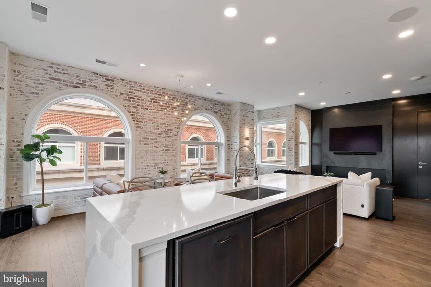 *Seller offering a $20,000 buyer incentive for contracts ratified by 2/28. Can be applied toward closing costs, rate buy-down, or purchase price.
Introducing The Penthouse at Towngate North — a rare opportunity to own a truly exceptional residence with unobstructed views of the DC skyline and Potomac River from a private terrace. Flooded with natural light, this 2023 designer-curated penthouse has been thoughtfully reimagined with bespoke modern upgrades that rival today’s new construction.
The open-concept living space is anchored by an Italian quartz waterfall island and a full JennAir appliance suite, while the living area features an imported Italian onyx porcelain statement wall with ambient, customizable lighting and a water-vapor art display — a striking focal point unlike anything else in the market.
Throughout the home, you’ll find custom millwork, concealed storage, integrated lighting, remote shades, and art-ready wall treatments. Bedrooms offer custom glass-front closets, and spa-inspired baths showcase floor-to-ceiling tile, waterfall quartz vanities, smart LED mirrors, and heated towel bars. Smart-home features include Sonos surround sound, Lutron dimmers, Brilliant wall controls, and Eero Wi-Fi.
Residents enjoy a fitness center, rooftop terrace, resident lounge, meeting rooms, dog wash, and two garage parking spaces (one EV-ready). Ideally located in the heart of Old Town Alexandria near the Mount Vernon Trail, acclaimed dining, and boutiques, with easy access to DCA and Washington, DC.
A rare penthouse offering with views, design, and now a compelling incentive — private showings encouraged.