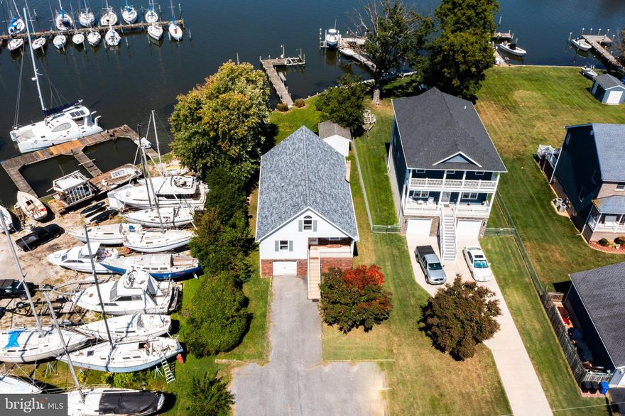 Set your sights on 7202 Waldman Avenue, the ideal catch for those who live for the water and the outdoors. This home is a dream come true, featuring a private pier with a boat lift on deep waters suited for both motorboats and sailboats. Built to last in 2000 & updated for your peace of mind, the property includes a roof and HVAC system replaced in 2020 and a garage door updated just two years ago. The large garage on the lower level has front and back doors, making it easy to store all your gear and still have room for two cars. There’s extra space down there too, ready for you to finish off into a cool hangout or extra storage. The main floor is all about living easy and enjoying the view. It packs a primary bedroom with its own bath, a handy second full bath, and common areas like the living room, dining room, kitchen, and a great room—all designed to make the most of those waterfront vistas. The kitchen’s even got a brand new oven that’s never been used. Upstairs, you’ll find a loft, plus another bedroom and a half bath. Outside, the yard is flat, easy to manage, and has some of the best views around, perfect for barbecues or just kicking back after a day on the water. The shed is perfect for additional waterfront toys. At 7202 Waldman Avenue, you don’t have to worry about flood insurance. This place is all about easy living and good times by the water—grab it before someone else does!