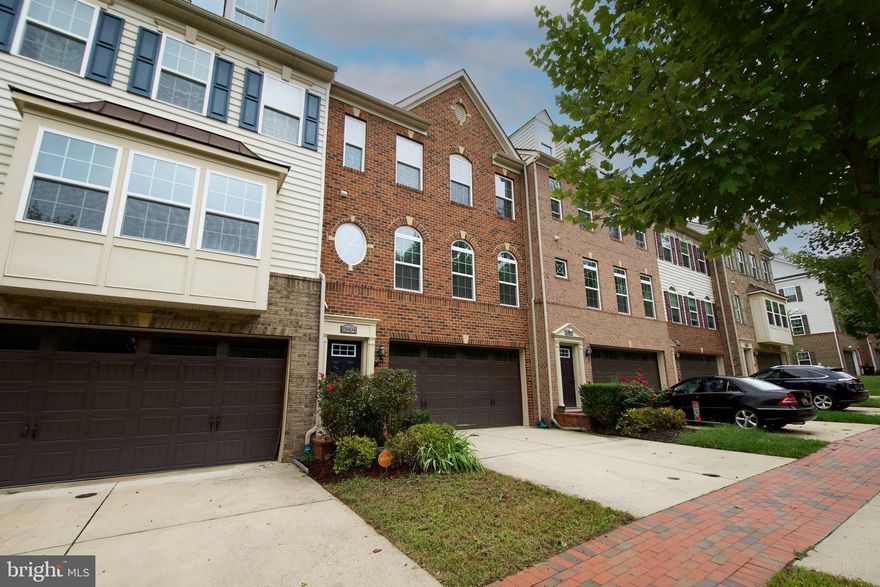 Bigger and better than new!  Spectacular, oversized brick front townhouse with a rear extension that allows for a bigger lower level recreation room, sunroom off the kitchen and sitting room in the primary suite.  This property boasts over approximately 2900+ FIN SQ FT with 3  bedrooms and  3.5 bathrooms, a full size deck for those evening sets and bbqs, two car front load garage, and a  rear fenced yard.  You'll be amazed at the room sizes and the impeccable finishes in this open and airy TH.  The stairwell is hardwood with metal railings.  There  is new lvp flooring on the main level and the carpet has been replaced throughout.  The main level boasts the sun filled living area, dining room w/wall niche, gourmet kitchen with double ovens, microwave, gas cooktop, pantry, oversized island, pendant lighting, hard surface countertops and loads of cabinet space.  The sunroom addition provides additional living space to use as you choose.  The large recreation room below will allow you to have stations for office, gym or recreation.  There is a double door that leads to the fenced yard for those quick pet outings, a bathroom and access to the 2 car garage.   The upper level is a masterpiece with a superb primary en suite  with sitting room, tub and shower in the primary bath, ample walk in closet space,  tray ceiling and columns,  convenient upper level laundry room,  and two light filled secondary bedrooms share a hall bathroom.  This property is turnkey with fresh  paint, new hard surface flooring in the living area and new carpet throughout.   There is ample guest parking. This is a premier community with an award-winning 18 hole golf course, lake, swimming, recreation facility, walking trails, restaurant/clubhouse and more.  Don’t wait, show and sell today!  This one has it all!  Please use the shoe covers!