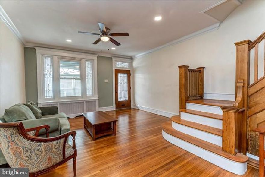 18,000 grant for qualified buyers .This one of a kind 4-bedroom townhouse on a well kept, tree-lined Cobbs Creek neighborhood, features original wood floors, crown moldings, stained glass windows, and classic tilework. The enclosed sun porch with tile floor, leaded glass, and fanlight windows, opens into a large living room with beautiful original hardwood floors, millwork, a tiled fireplace, and refinished, original natural wood staircase. The well -appointed formal dining room has original features with a pass-through breakfast bar. A large full-size kitchen with granite countertops has brand new Frigidaire appliances. The second floor has 4 large bedrooms with beveled glass full-length mirrored closet doors. The full bath is restored with ceramic tile walls and flooring. A pedestal marble sink enhances the original charm. The fully finished basement has been updated with space for a playroom and exercise area, a full bath with a standing shower. An egress door leads to a large paved backyard. The family-friendly neighborhood is near a professional ice skating rink, brand- new Cobbs Creek Nature Playground, the Environmental Center, hiking and biking trails, a recreational center , basketball courts, and tennis courts. Accessible to the 34 trolley /and El train minutes to center city of Philadelphia. The trip to Philadelphia International Airport is 15 minutes no traffic through the park. Hurry won't last !!!! The seller is very motivated and this house qualifies for 100% financing at Meridian Bank because of it's location. see documents for 100% financing Meridian Bank. seller will give seller assist depending on the offer.