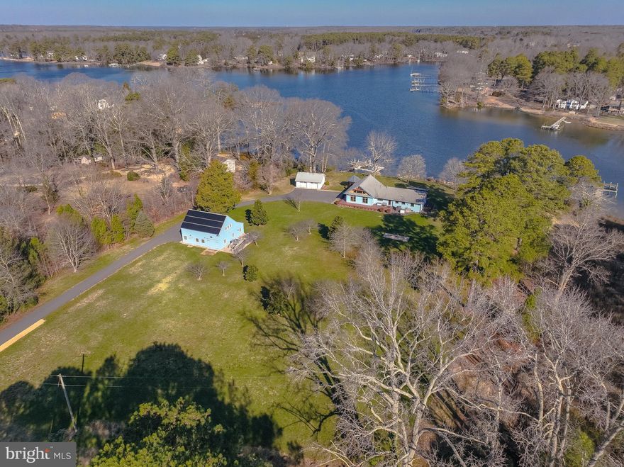 Nestled within a protective deep water cove, this stunning waterfront home is a real find.  With 300ft of water frontage on almost 3 acres of professionally groomed setting, you will always feel like you're on vacation.  Meticulously cared for, with attention to detail, best describes this home.  Beautiful kitchen, complete with stainless steel appliances, granite counters, wall oven, and gas cooktop, makes cooking a delight.  Loads of natural light set off the gleaming hardwood floors, wood-beam vaulted ceilings, and expansive windows frame panoramic water views.  The  double-sided, freestanding stone fireplace exudes rustic charm and stands as a focal point, adding both aesthetic appeal & functional comfort.  Don't miss the  unfinished lower level, tucked away under the retractable floor door, providing ample room for hobbies, a workout area, storage, or any other personalized use.  Hardy Board siding ensures durability, while a large wraparound, wood-look aluminum deck provide low maintenance outdoor living.  And close by there is a two car garage equipped with a 48A/240V Tesla charger

The private pier is complete with two lift systems, including a Magnum HD 8000 lb and a Mini 2800 lb lift, ensuring hassle-free storage for watercraft.  A ramp for small boats or kayak launching further enhances easy accessibility, inviting exploration of the serene coves or boating ventures out to the St Mary's River, Potomac River or Chesapeake Bay!

The New England post and beam barn makes a grand statement too!  The barn's classic design, with unique stair system to upper deck storage, adds to rustic feel, perfectly complementing the natural beauty of the surroundings.

Mechanicals to include: variable speed heat pump with propane backup; tankless water heater;17 KW Generac propane power backup stands ready to provide peace of mind during inclement weather; and full house reverse osmosis and water softening systems.  And another big plus is a state-of-the-art solar system comprising 27 400-watt solar panels with a perfect unblocked southern view, offering both sustainability and energy efficiency.

Take a look to discover more hidden gems not listed here!