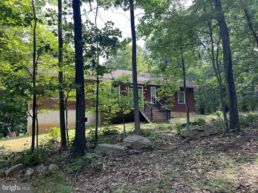 Come See this Custom Built 3 Bedroom, 3 Bathroom House Sitting on 10.02 Acres (lots 20 & 21 combined).  Beautiful Locally Milled Ash Hardwood Floors throughout the First Level.  Large Custom Windows and Crafted Trim.  Walk-In Pantry with Shelving and Cabinets.  New Kitchen Cabinets and Stainless Appliances.  In the Guest Bathroom, Newly Installed Tiles and Fixtures.  Primary Bathroom has Large Soaker Tub and Walk-In Shower.  Stackable Washer and Dryer on First Level.  The Basement has a Full Bathroom and Large Shower.  Main Part of the Basement will need to be Finished, However, Seller is Including Building Materials to make the Job Easier - Some Materials Include Drop Ceiling Tiles, Dry Wall, Insulation, Trim, Etc. There is Enough Ash Hardwood to Finish the Stairs.  Seller is also Offering up to $5,000 for the Completion of the Kitchen with Acceptable Offer.  Note:  Seller's are still working on small projects in the house.