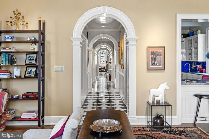 The character of a historical Society Hill townhouse has been beautifully recreated at this 2,300-square-foot penthouse at The Lanesborough. With architect Spence Kass overseeing the design, the former billiards parlor of the c. 1929 University Club has been transformed into a superbly finished, very livable center-hall apartment with outdoor space on three sides. The elevator delivers you directly to a reception foyer with a mirrored tray ceiling with cove lighting and sparkling, classic, checkerboard marble floor. Rich millwork trims a sequence of arched doorways that lead to the main living spaces. At the southern end is the grand living room with a deep tray ceiling, French doors opening to a terrace with long-distance views and distinct sitting areas with windows on three sides. Well suited to entertaining, the floor plan features a formal dining room with a tray ceiling and built-in storage on two walls. The smartly designed cook’s kitchen provides pro-grade appliances (six-burner Wolf gas range; separate electric wall oven; two paneled Sub-Zero refrigerator/freezers), a tile backsplash and timeless white cabinetry. One special feature is the bar seating in the kitchen with a pass-through to the living room that can be closed off for formal entertaining or serve as the bar for a party. There are other clever features like this designed into the apartment. Spoking off the gallery-style center hall are the main suite bedroom and a guest bedroom/office, each with access to terraces. Enjoy the view while you soak in the jetted tub in the onyx main suite bath, which also has an underlit double vanity and marble stall shower. A walk-in closet with built-ins completes the main suite. The marble hall bath is finished with an oversized, seamless glass shower and marble-topped vanity. To add to its appeal, this apartment also has a full-sized laundry and utility room with access to a terrace plus an additional walk-in hall closet. There are hardwood floors in all of the main rooms, plenty of recessed lighting, pocket doors, central vacuum connections throughout, a wealth of storage in the apartment plus extra storage room in the basement measuring approximately 12x18 with 12ft ceiling, hot-water heat and high-velocity central air. The Lanesborough is a 24/7 doorman building, dog friendly, with fitness center for residents. This is a must-see for the buyer looking for 180-degree views, outdoor space and a supremely comfortable floor plan in the heart of Rittenhouse Square.