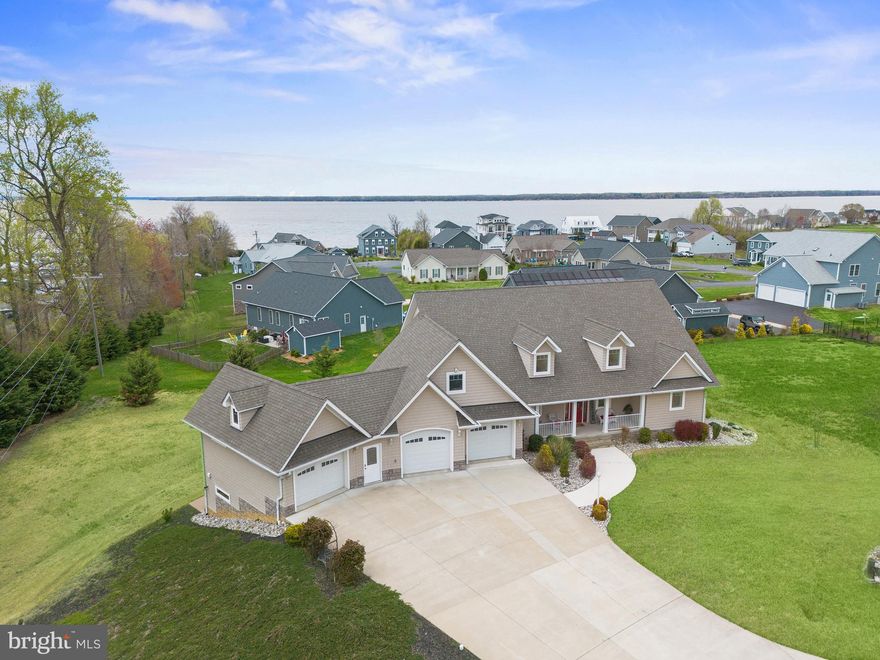 Vista is in its name –  prepare for Potomac River vistas, state of the art technology paired with stunning craftsmanship, inside and out. Introducing the one-of-a-kind, meticulously
crafted gem that is 6315 Vista Court!
Built in 2014, this Potomac Landing residence includes six bedrooms, four baths and
over 5100 square feet of finished, dynamic living spaces. It is tucked on a .69-acre lot
in the prized Potomac Landing community. What a walkable and golf-cart lifestyle here,
folks! The community includes a private beach, private freshwater fishing lake, deeded
river/marina access and multiple sports courts. Marinas, restaurants, and water
activities are all right there at Fairview Beach.
Zooming in on the acreage, an extra-wide, concrete-driveway (parking for 8-plus
cars!) segues to the residence’s four-bay garage with an interior workshop. The Zoysia
grass-clad landscaping is low maintenance. Off the back of the residence are multiple
balconies and decks for taking in the sweeping river landscape. Favorites of the current
owners include the flagpole out front and the friendly wildlife – it’s not uncommon to see
bald eagles soaring above or nearby! If family needs weren’t taking the current owners
across the country, this would be their lifelong residence for sure.
Construction-wise, the home is ICF (insulated concrete form) construction at its finest,
equating to one of the most air-tight, health-oriented, and energy-efficient options on the
market! The home is also geothermally positioned at the end of a cul-de-sac, meaning
its location and windows have been scientifically situated to invite warmth when needed
and keep electric bills super-low. Features include an Energy Recovery Ventilator (ERV)
system that enhances indoor air quality and maximizes energy recovery, a whole-house
generator, Ultra-Air XT155H dehumidifier, Mitsubishi ducted and ductless HVAC units, two
outlets for Tesla charging in its garage and much more. This home is fully equipped like
few others – a full list of its features is available upon request!
Situated two streets off the Potomac River, views of the river are maximized across all
three levels of the Cedar Cove-sided abode. The interior touches – distinctive trim, cozy
window seats and quiet nooks – truly shine. Inside, highlights of the 1,700 square-foot
main level include an open and cherry wood-clad foyer as well as its family room and
kitchen combo. This is a true chef’s kitchen complete with stainless steel appliances, a
large center island, expansive cabinetry and – for coffee lovers – there is even a
separate coffee space and breakfast station. Rounding out the main level are its huge
screened-in patio, and we certainly can’t forget the main level primary suite here,
complete with an ensuite bath with double-wide shower.
The upper level boasts two bedrooms, two bonus/flex rooms and a full bath. The lower level
– measuring approximately 1,400 square feet – includes the home’s final two bedrooms
and full bath. The lower-level space may easily serve as its own apartment, and it is
electrically equipped for a future kitchenette. On the lower level, let’s not forget the wine
cellar, oodles of storage space and the massive Dolby ATMOS sound-proof theater with
surround sound and built-in cabinets. The theater can serve as a safe room as well!

Beyond the Potomac Landing community, so much is within minutes. From its doorstep,
Downtown Fredericksburg, Dahlgren  and the US-301 Harry Nice Memorial Bridge are within 15
minutes. The home is serviced by King George County Public Schools, with Sealston
Elementary, King George Middle and King George High as its designated institutions.
Unique and rare don’t begin to describe the magic at 6315 Vista Court – it must be seen
to be believed! Book your showing ASAP.