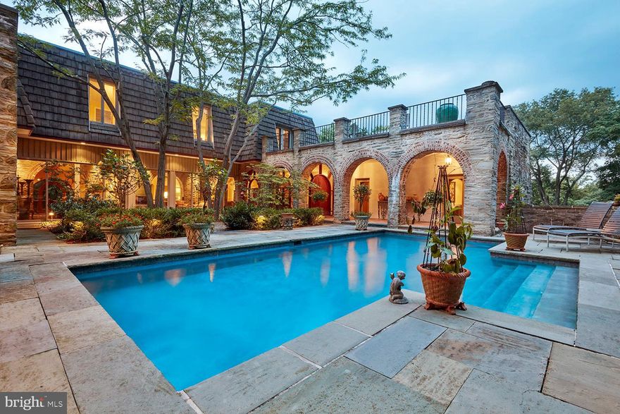 Welcome to the best of Chestnut Hill! Exceptional 5 bedroom stone-clad jewel on a private drive, just a short walk to the train, Fairmount Park, and restaurants and shops of the coveted garden district. Noted architect Theophilus Chandler designed Stonecliffe in 1880. The mansion tragically burned to its foundations in the 1920s. It then began a second life when the owner's daughter built an Olympic-sized swimming pool amidst the stone ruins while she continued to live in Greystock, a neighboring house built for her by her father as a wedding present. In 1971 architect Richard Martin removed most of the pool and within the still standing mansion walls fashioned a new residence centered around a sunken courtyard and secluded garden. The present owner, also an architect, rebuilt the pool, upgraded and re-landscaped the entryway and courtyard, and modified much of the roofing to expose more of the original stonework. One enters the home by descending into the hidden courtyard and approaching the arcaded porch and front door. A gracious foyer opens to the glass and stone great room, which leads into the light-filled living room overlooking a private courtyard. A massive raised hearth with floating hood separates living and dining areas, while more arcaded arches define a zone for artwork, music, and billiards. The adjacent den with arrow-slit window views overlooks a downstairs office and opens onto the courtyard and pool area. A sleek chef's kitchen features exposed stone, polished granite, and stainless steel appliances including a Thermador triple combination wall oven and 2 Miele refrigerators. Among the five second-level bedrooms you will find a serene owner's retreat complete with dressing room/walk-in closet and private roof deck. Another large deck ideal for entertaining is located off the second floor landing and offers unrivaled views to the north and forty miles to the west. Blending historical charm, classic elegance and modern light and openness, this magnificent home is perfectly nestled on a private lane less than a mile from the center of the charm and amenities of Chestnut Hill.