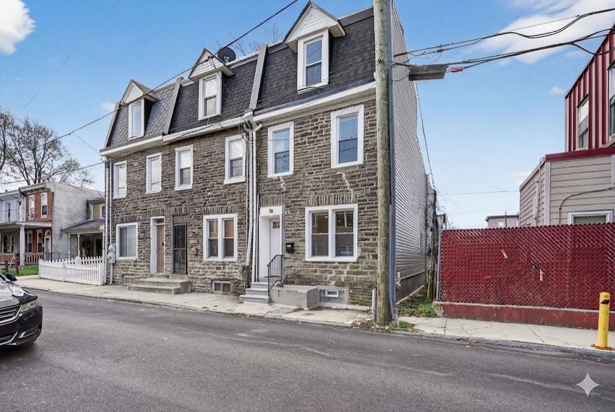 GORGEOUS HUGE PROPERTY IN WEST GERMANTOWN! This meticulously reimagined 3-story stone townhome offers polished living space featuring 4 bedrooms and 2.5 designer baths. The open-concept main level shines with natural light, featuring an electric fireplace and durable wide-plank flooring. The chef’s kitchen is a showstopper, anchored by a custom quartz center island, white/gray shaker cabinetry with self-closing drawers, custom tile backsplash, and updated stainless steel appliances.

Step out from the kitchen to a private, fully fenced rear patio—perfect for summer hosting. The upper levels host 4 spacious bedrooms with custom-fitted closets and two luxury full baths featuring high-end vanities and tile work. The heated, semi-finished basement provides the ideal footprint for a home gym or media room, plus a dedicated laundry zone with a new washer/dryer.

NEWER EVERYTHING: Goodman High-Efficiency HVAC, newer roof, newer siding, energy-efficient windows, and updated plumbing/electric. Located minutes from Queen Lane Station, Wissahickon Creek trails, and the shops of Chestnut Hill & Mt. Airy. Easy access to Rt 1 and Center City. Move-in ready luxury in a premier historic location. Schedule your showing today!