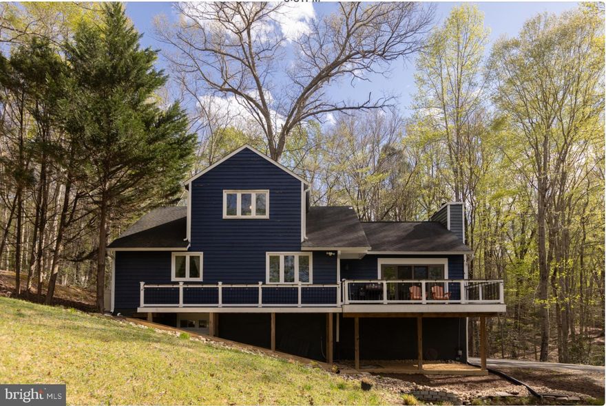 Rustic hillside retreat with stunning views of Springhill Lake, which feeds into Lake Occoquan. Nestled on nearly 2 private, wooded acres with a long driveway crossing a gentle brook. Spacious main-level deck perfect for enjoying nature. Just 10 minutes to the commuter rail and across the water from Bull Run Regional Park.

Many updates:  kitchen Renovated ( 2018-2019), Bathrooms Renovated (2020), Roof Replaced(2018), Whole HVAC System (2020), Water heater (2024), and  Septic  cleaned on Recently.  and more updated on 2024.
Great move in  condition, sold As-Is. A rare blend of privacy, nature, and convenience!