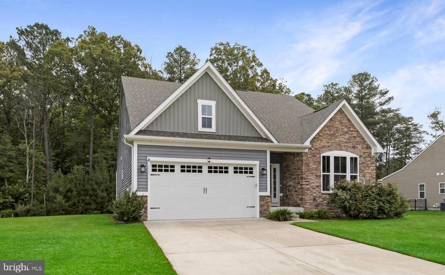 This beautifully maintained ranch in the sought-after Spring Breeze community combines one-level living with built-in room to grow. Inside, the home features a smartly designed floorplan with vaulted ceilings, an open-concept great room anchored by a cozy gas fireplace, and a chef’s kitchen with a large island, walk-in pantry, and stainless-steel appliances. The flexible third bedroom—currently used as an office with French doors—can easily be converted back to a bedroom with a simple closet addition. The spacious primary suite offers a tree-lined view, walk-in closet, and a spa-like Roman shower. Step outside to the professionally designed patio with lighting, multiple seating areas, and private wooded backdrop—perfect for entertaining or unwinding. **But the real opportunity lies below: the full unfinished basement offers tons of expansion potential. Already framed for additional rooms and plumbed for a full bath (including a soaking tub), it’s a blank canvas for a recreation space, guest suite, or home gym. With shelving and storage in place, it’s both practical now and future-ready.
Living here means more than just a home—it’s a lifestyle. Spring Breeze includes lawn care, trash service, clubhouse, pool, and fitness center, all minutes from Rehoboth and Lewes beaches, Millsboro, and Georgetown.