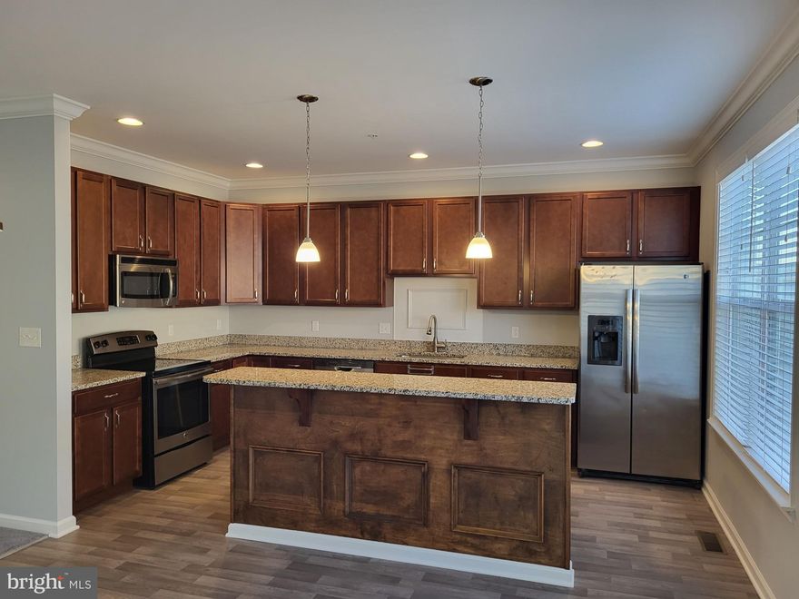 Coming soon.  This like-new, 3-level townhome located on Kent Island and nestled within the highly sought-after Ellendale community. Freshly painted and upgraded, boasting crown molding and sun-filled windows that flood the space with natural light. The open floorplan seamlessly connects the living room, dining room, and kitchen, creating a welcoming atmosphere for everyday living and entertaining. The large living room features elegant crown molding and a cozy gas fireplace, adding warmth to the space. The Chef's kitchen, offers wood-tone cabinetry, granite counters, island with breakfast bar, stainless steel appliances, and  pantry for added storage.  Just off the kitchen is the dining room, which opens to a large composite deck through a sliding glass door, providing a wonderful outdoor space for relaxation and gatherings. On the upper level, the primary bedroom  features a walk-in closet and full bath with a double vanity, separate shower and soaking tub. Two additional bedrooms, a full bath, and  laundry room as well. The entry level provides a versatile room that could be office, play room or 4th bedroom if needed, a half bath, and a foyer with a built-in drop zone for organization. The finished 2-car garage has epoxy flooring and auto opener. Residents also have access to a community clubhouse, out door pool, and a playground. Situated in a prime location, this townhome provides easy access to shopping, numerous restaurants and recreational activities that Kent Island has to offer, and it's only minutes away from the Bay Bridge.  Terrapin beach and Matapeake beach, along with the cross island trail are just minutes away as well.