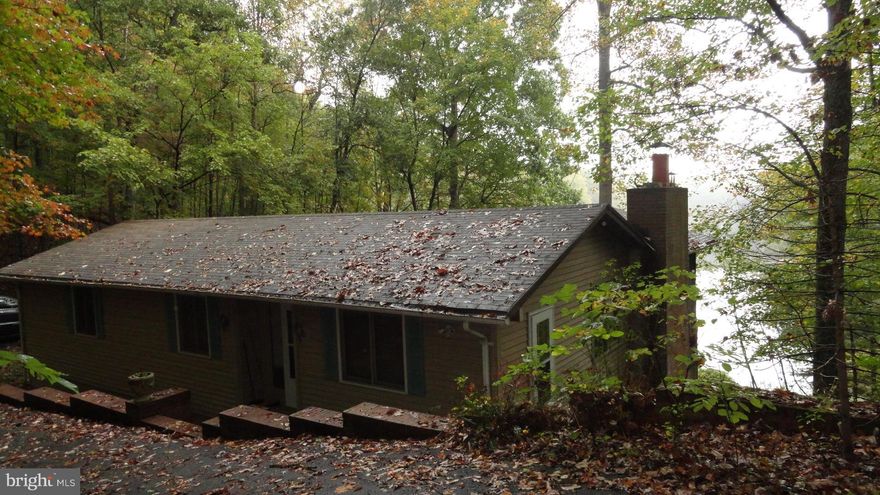 100+ Ft of WATER FRONTAGE!! Sit on the screened in PORCH, Covered Patio or DECK & enjoy the Mountain & Water VIEWS!!  Want more space?--Lot 89 next door is for sale at $37,500--its also water front (see JF10081159) House features 2 FIREPLACES.  Recently updated kitchen.  The rest of the house is just waiting for you  to make it your own.  Both Baseboard & Radiant heat. Comcast internet available.