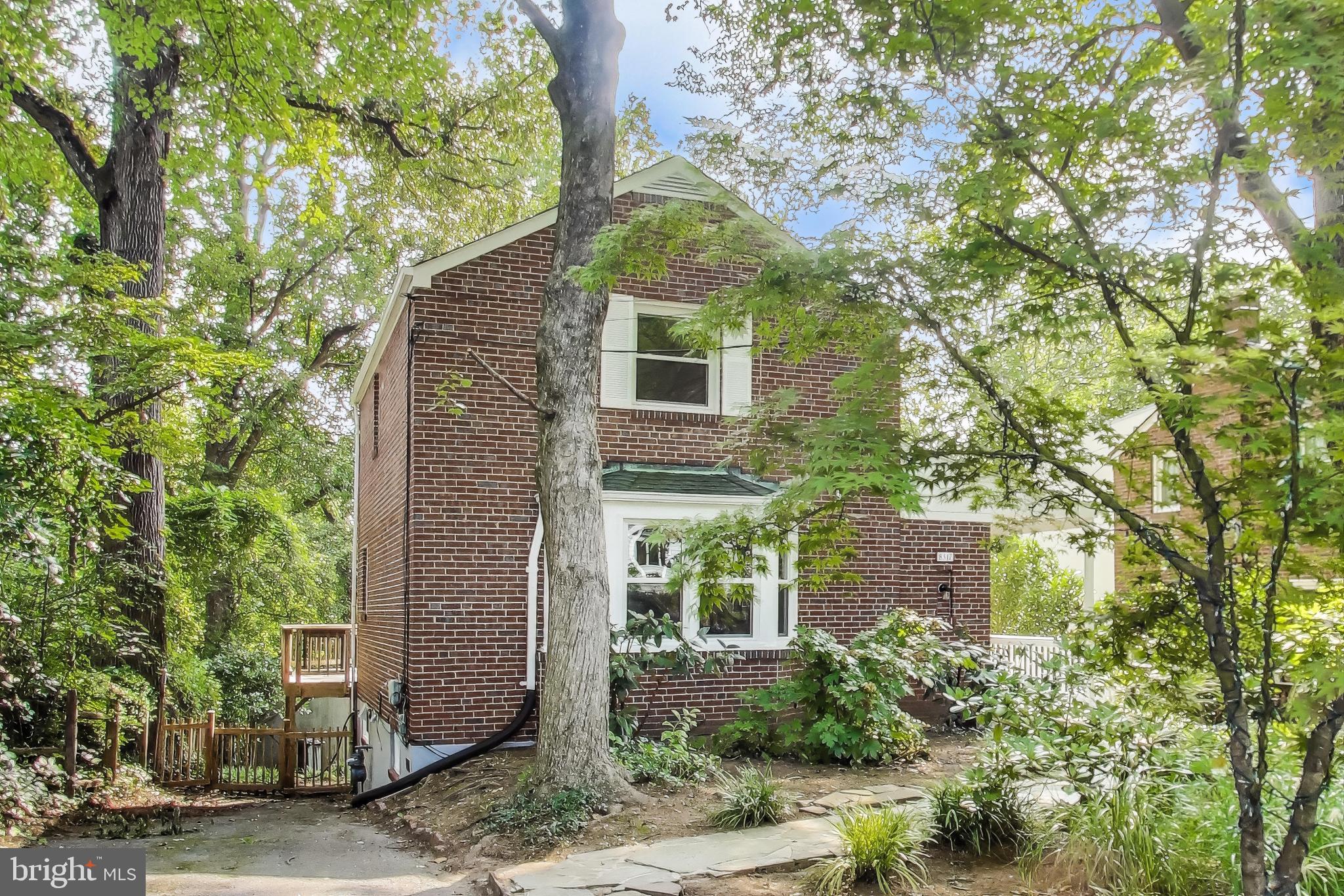 Beautiful THREE LEVEL 3 + 2 wooded lot with gorgeous finishes throughout this Classic BRICK Takoma Park property! Front entrance opens to light and bright living room with Exposed Brick wall , separate dining room and glorious sunroom addition!! Updated kitchen with gas cooktop and wall oven, unique wood island, nice sized work station and stainless appliances. Fully finished walk-out basement with large bedroom and full bath, awesome built in closet space and second living room. Two bedrooms upstairs with large full bath. **** Rear wooded and peaceful yard with huge deck, patio and fenced in yard! Easy access to trail system (ACCESS FROM BACK YARD!), local ES schools, shopping, restaurants, commuter routes, DC & so much more!! Entire Interior and Exterior of the home has been freshly painted! A few words form the Sellers: The reason we bought this house was-- "The trail and creek behind the house, Rolling Terrace School, the bridge that connects the neighborhood to the school, & downtown Takoma Park, and now the nearby purple line METRO."