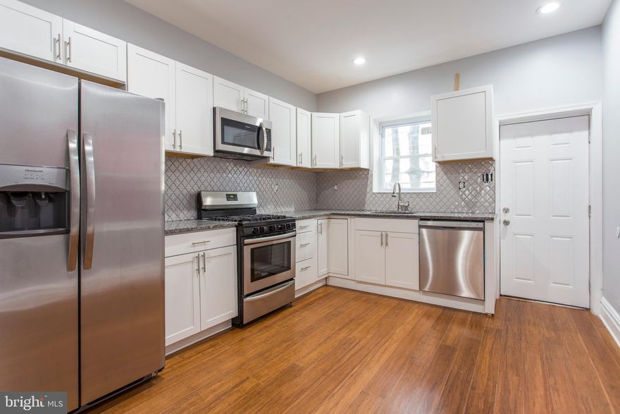 A beautifully rehabbed home you need to see! This property immediately impresses with features such as bamboo hardwood flooring, high ceilings, recessed lighting and large windows throughout for ample natural light! The open living and dining room is ready and waiting to accommodate any furniture arrangement you desire, in addition to naturally leading past the powder room and into the lovely, modern kitchen, complete with stainless steel appliances,granite counters, tiled backsplash and beautiful cabinetry. The kitchen also includes access to a charming rear yard- just the spot for you morning cup of coffee or lounging on a warm, sunny afternoon! Upstairs, discover the nicely sized bedrooms with ample closet space, and lovely hall bathroom with custom tiled tub and shower. For those looking for a little more indoor space the fully finished, carpeted basement is ready to be turned into a rec room, office, playroom, home theater, family room- your choice! Found in the Penn enhanced mortgage zone, this home is just a short walk to Mercy Hospital, the 34 trolley, 52 & G bus routes, as well as a short bike ride to U. Penn, University of the Sciences, not to mention you can bike downtown in about 10 minutes. With all of this, what are you waiting for? See this home today!