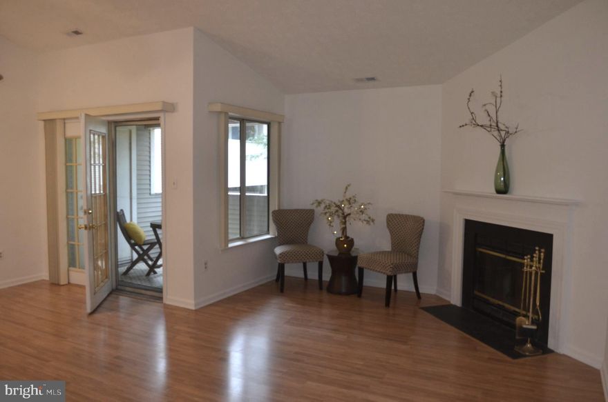 Perfectly ready to move in!! Or, could this be your investment property? Light & Bright! Vaulted ceilings on this top floor condo in an incredible location! Two large bedrooms with two full baths that each have shower/tub combo.  Open floorplan with kitchen bar opening to large living room with wood-burning fireplace. French doors lead to your private balcony with a screen door. Kitchen has BRAND NEW stove/range and dishwasher! Full-sized washer/dryer - BRAND NEW washer! Bedroom 1 has two large closets. Primary Bedroom has vaulted ceiling, HUGE walk-in closet and en suite full bath with tub/shower combo. BRAND NEW carpet in both bedrooms, wood-look laminate throughout whole condo. Plenty of parking too! One assigned space in front of building and always plenty of additional spaces available. Minutes to everything! Frederick has so much to offer - Restaurants, shopping, a thriving downtown with community events, Baker Park, Carroll Creek, and easy access to all major highways yet a quiet setting.