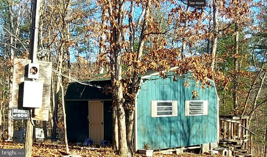 This wooded lot is not just a piece of land; it's a ticket to your very own mountain escape. Picture this: 2.12 acres of pure serenity at the end of the road, where seclusion meets adventure.  This parcel is tucked away like a well-kept secret!  A charming building/shed, perfect for storing your outdoor treasures or transforming into a cozy camp hideaway. And did we mention the stream? A small tranquil stream wanders through this property!  But the magic doesn't stop there. Just a stone's throw away lies a public access point to the South Branch of the Potomac River. Whether you're into fishing, floating, kayaking, or just a refreshing swim, your river playground awaits.  Worried about nosy neighbors? Fear not! The HOA here is here for your peace of mind, with easy and sensible restrictions to ensure harmony without cramping your style.   But wait, there's more! If you fancy a lazy afternoon of casting lines and enjoying a picnic, the community's catch-and-release pond is your go-to spot. It's not just a fishing hole; it's a picturesque retreat where you can pass the time away!  This perfect little hideaway is centrally located for all who feel the need to wander to WV every now and then.  15 minutes to Romney (shopping, dining, conveniences); 30 minutes to Cumberland, MD, just over an hour to Winchester, VA and 2 hours to the Dulles/DC area!  Don't let this opportunity slip through your fingers like a slippery trout. This very affordable mountain getaway is calling your name. Pack your sense of adventure, your love for nature, and a dash of whimsy – because this West Virginia wonderland is ready to welcome you home. Seclusion, stream, and shed included. What more could you ask for? Make it yours now and let the mountain magic begin!