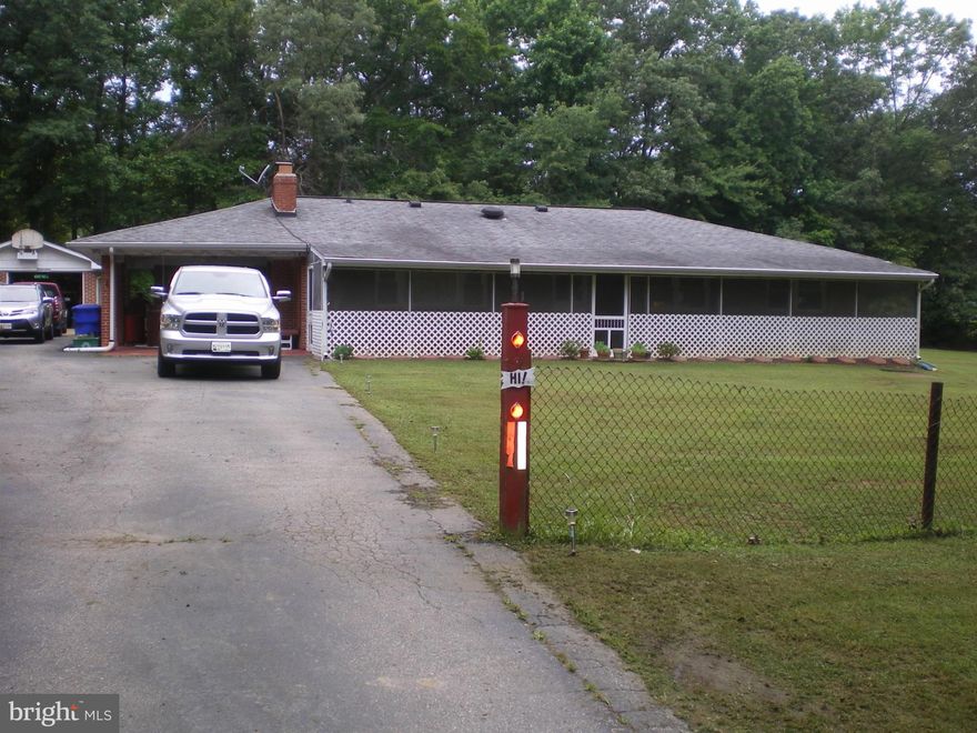 WOW WHAT A YARD, Great for family reunions, picnic area w/horseshoe pit & wood stove great for campfires. Located on dead end street, with privacy and plenty of parking.  Well maintained, BIG living room with fireplace, detached garage, carport with hot tub that conveys, separate laundry room, shed.  Screened in front porch. LOOKING for privacy you don't want to pass this one up